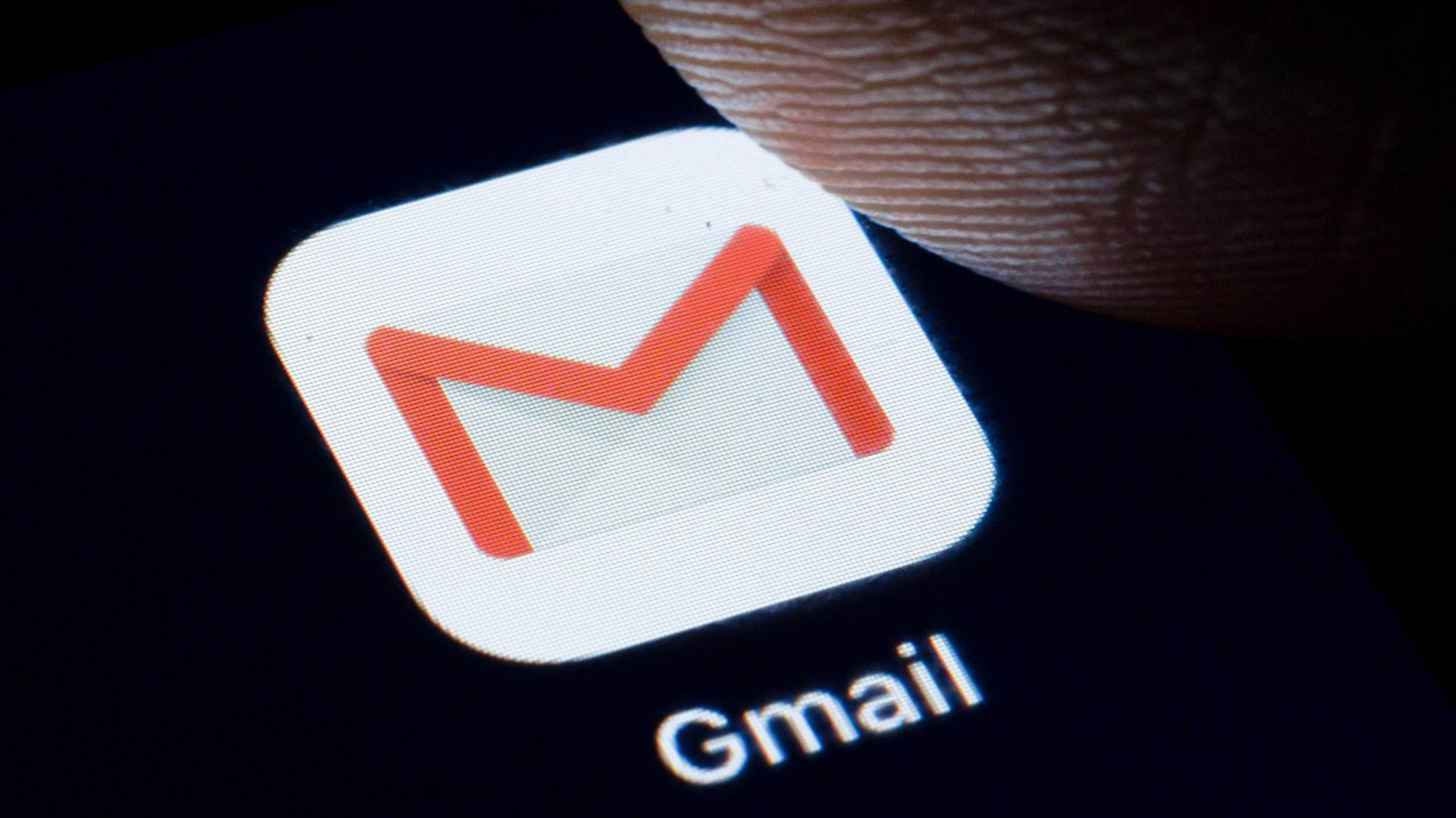 The Logo of Gmail is displayed on a smartphone