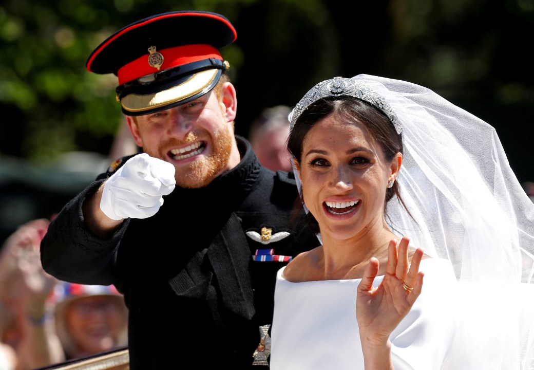Meghan and Harry wave to the crowd after their wedding