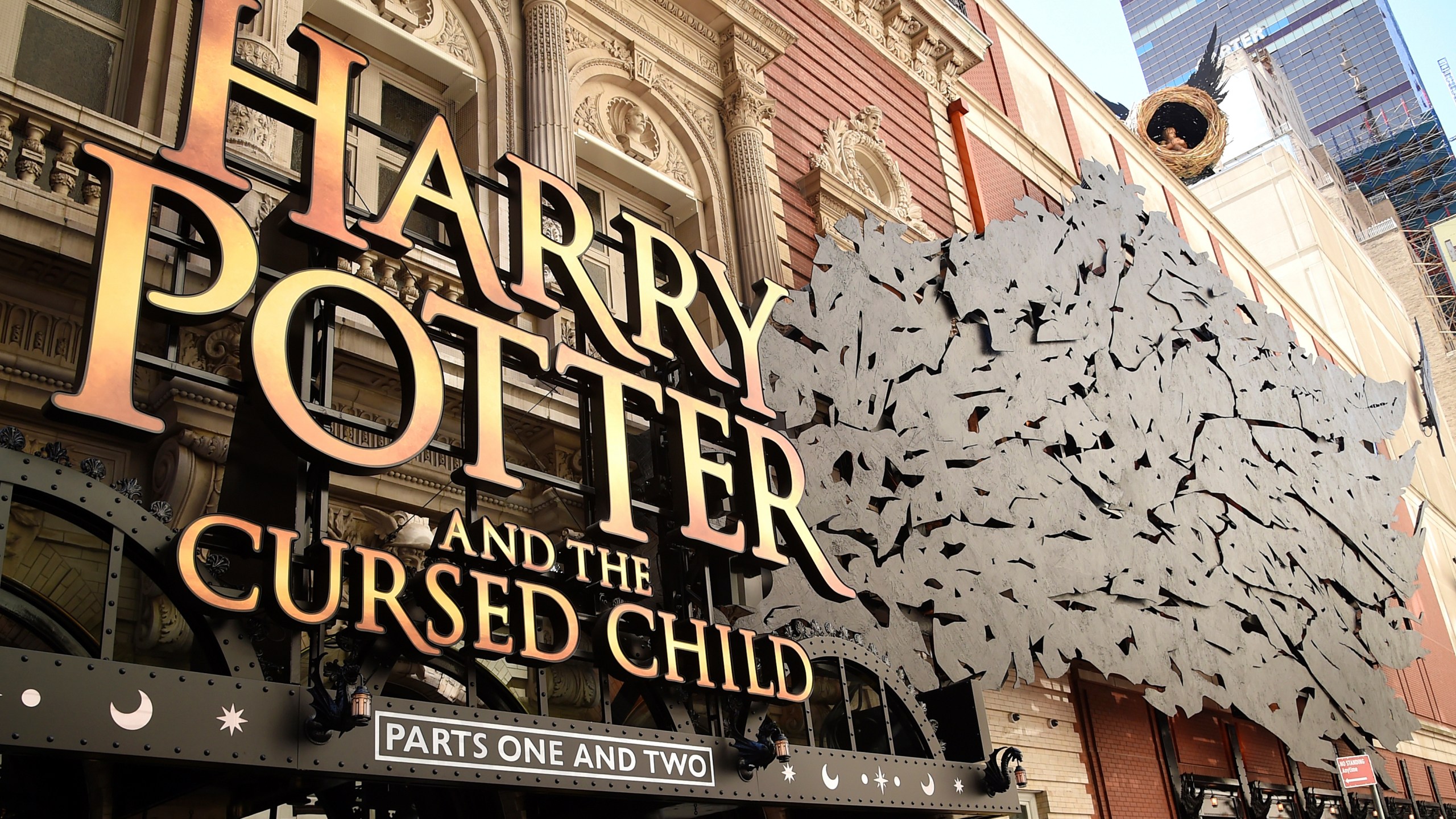 A sign for "Harry Potter and the Cursed Child" hangs at a theater