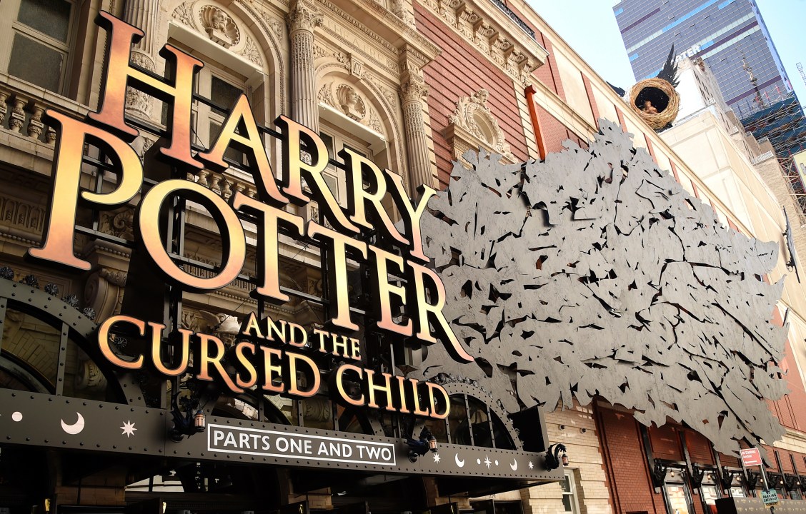 A sign for "Harry Potter and the Cursed Child" hangs at a theater