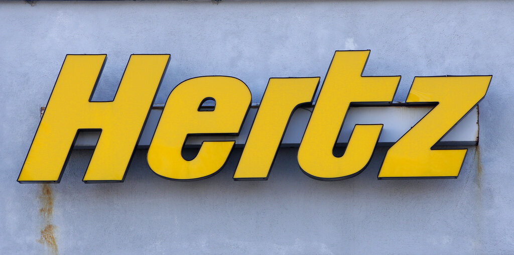 A Hertz rental car logo rests on the front of a Hertz location, in Boston. (AP Photo/Steven Senne, file)