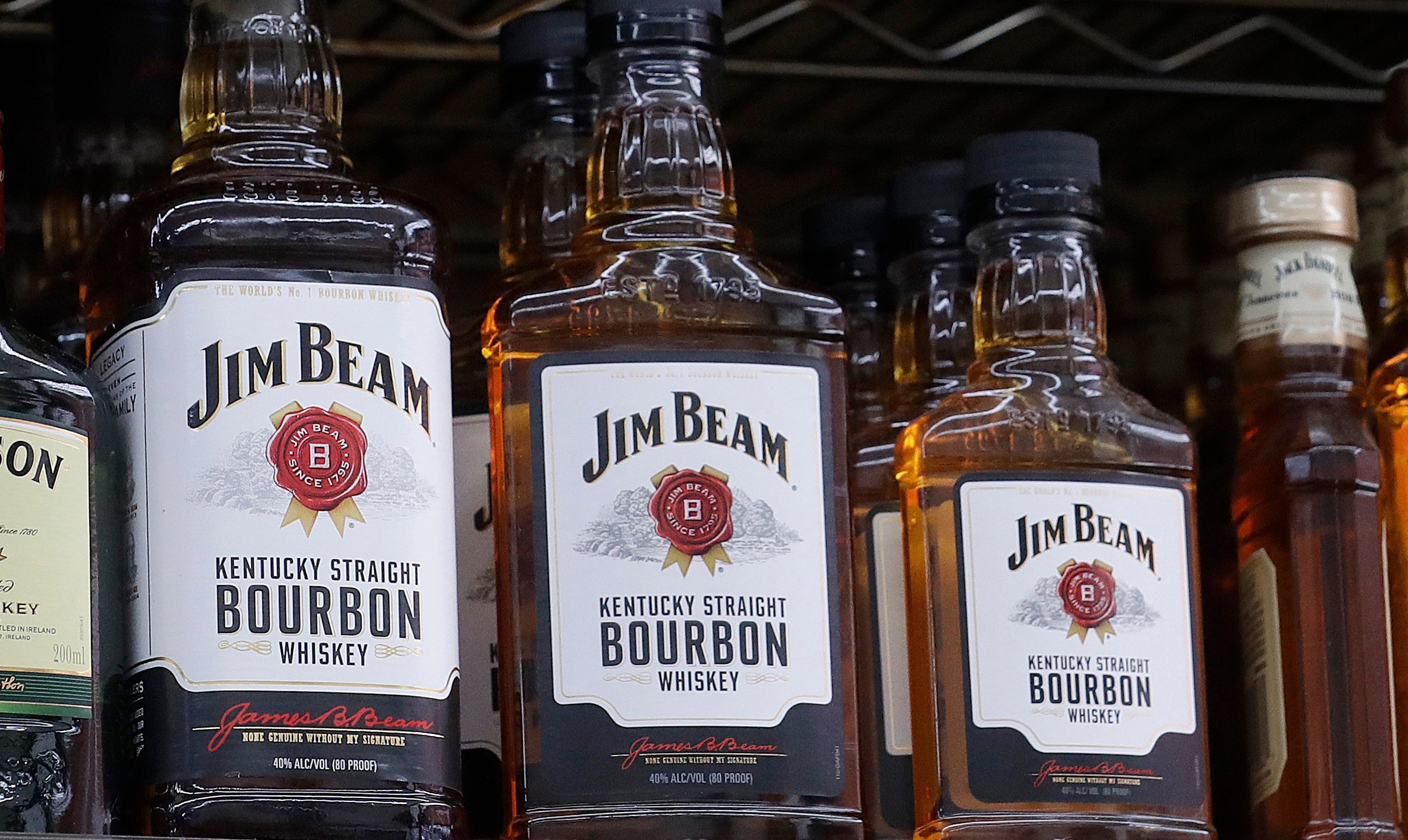 Bottles of Jim Beam bourbon with a white label on the front of the bottle
