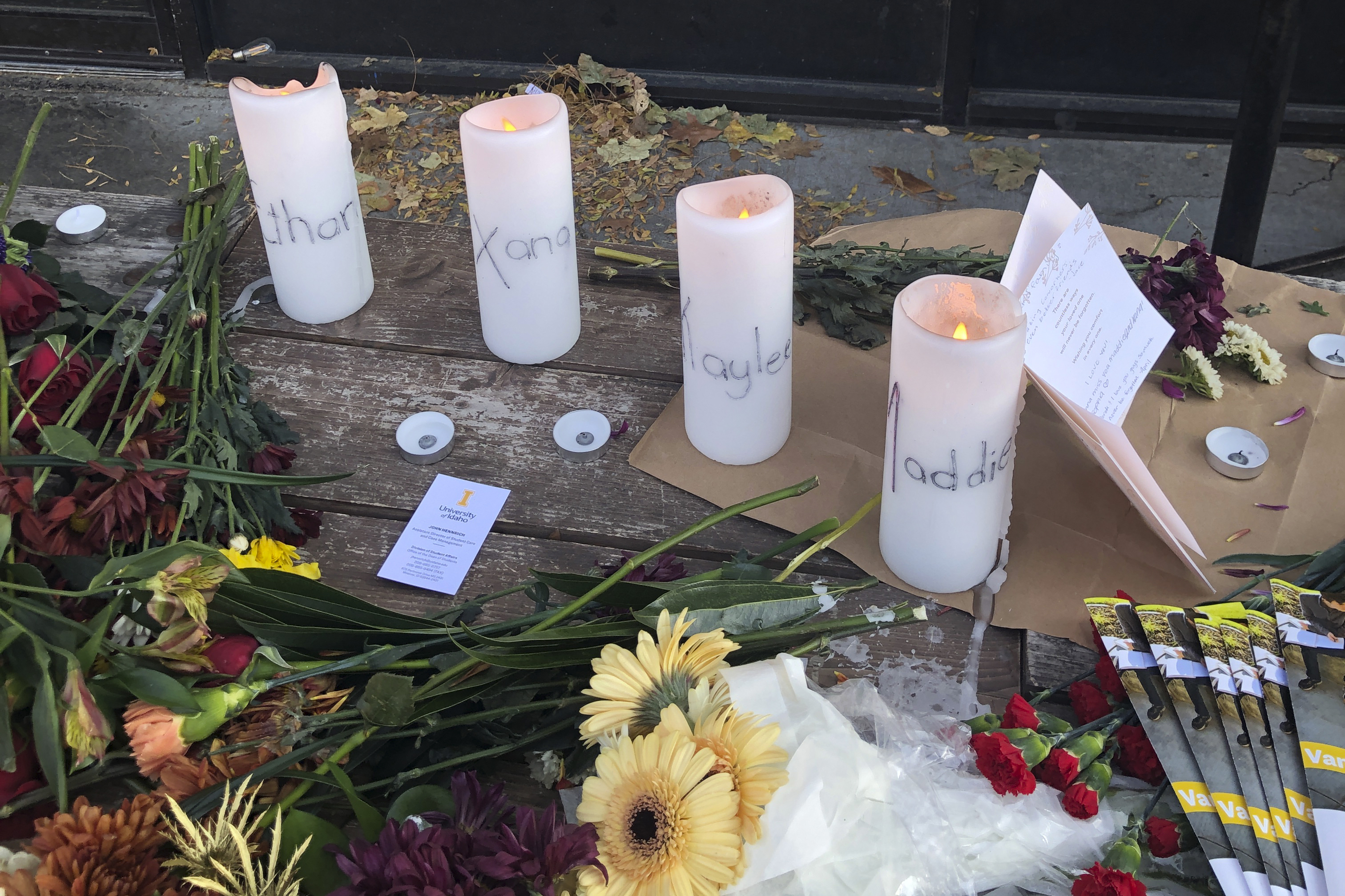 Candles and flowers are left at a make-shift memorial honoring four slain University of Idaho students outside the Mad Greek restaurant in downtown Moscow, Idaho, on Tuesday, Nov. 15, 2022.
