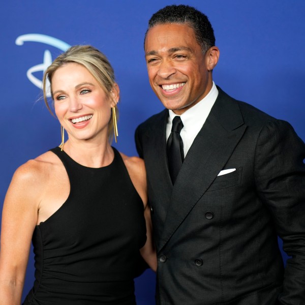 T. J. Holmes, Amy Robach pose for photos at an event