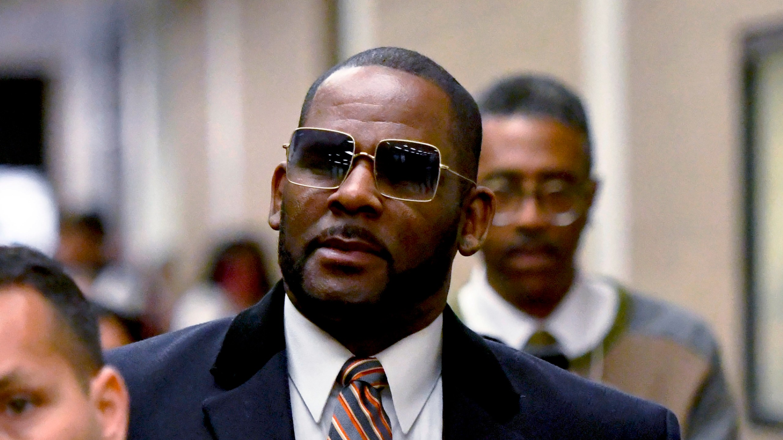 R. Kelly, center, leaves the Daley Center after a hearing in his child support case May 8, 2019, in Chicago.