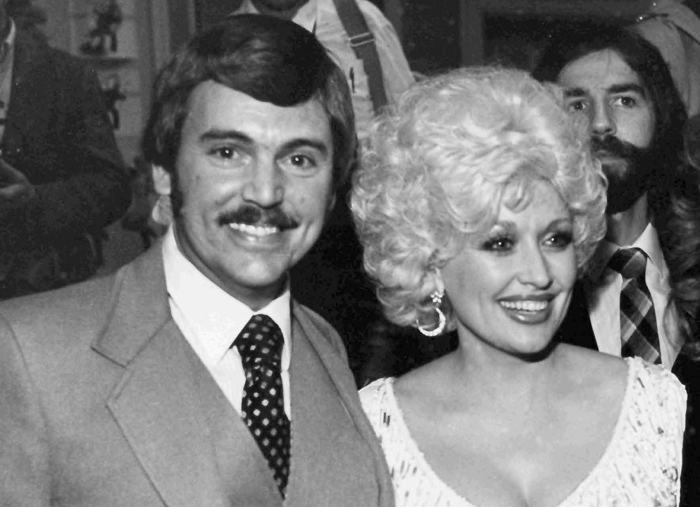 Newsman Joe Edwards poses with Dolly Parton at an awards reception