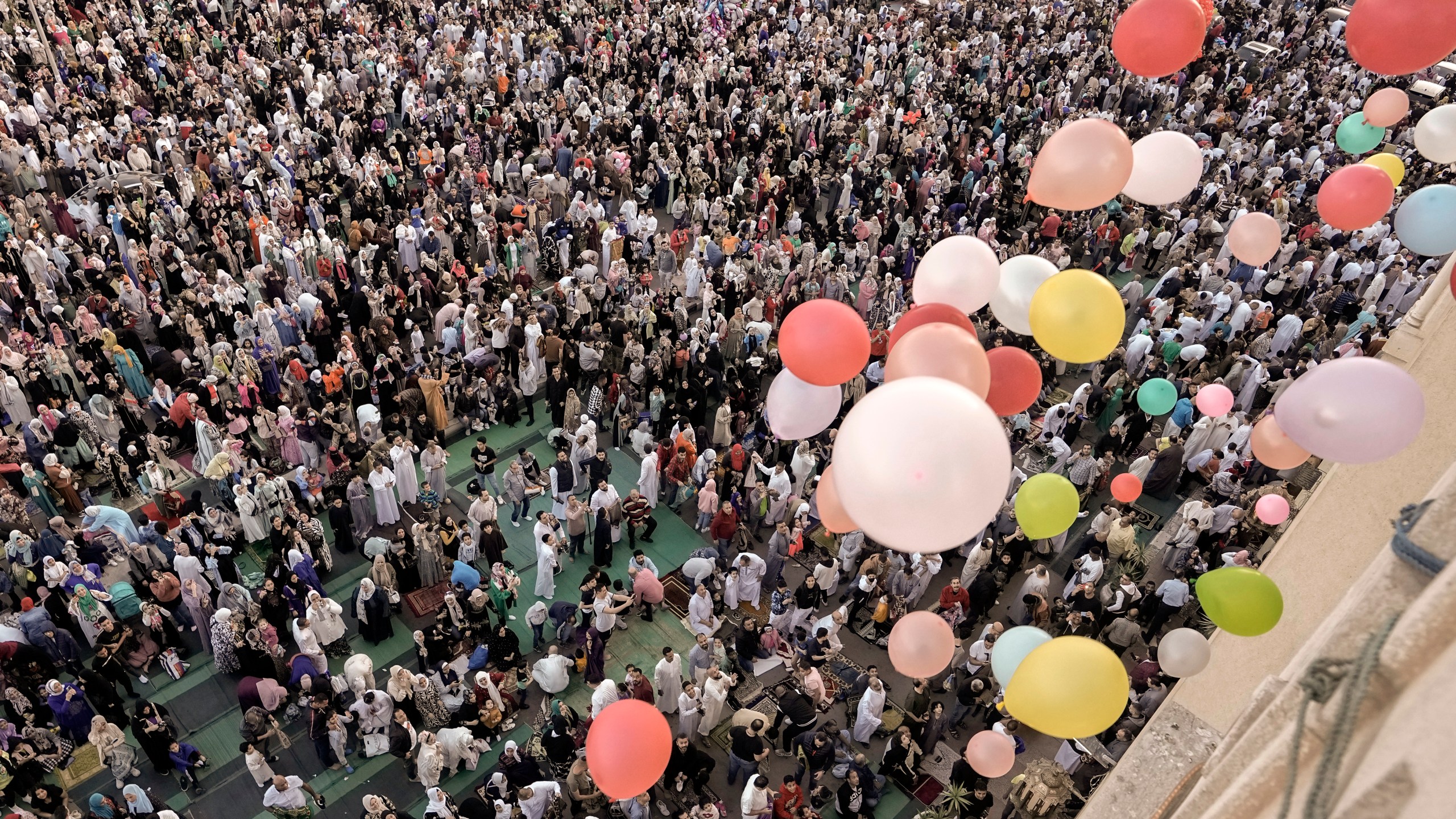Balloons are distributed for free after Eid al-Fitr prayers.