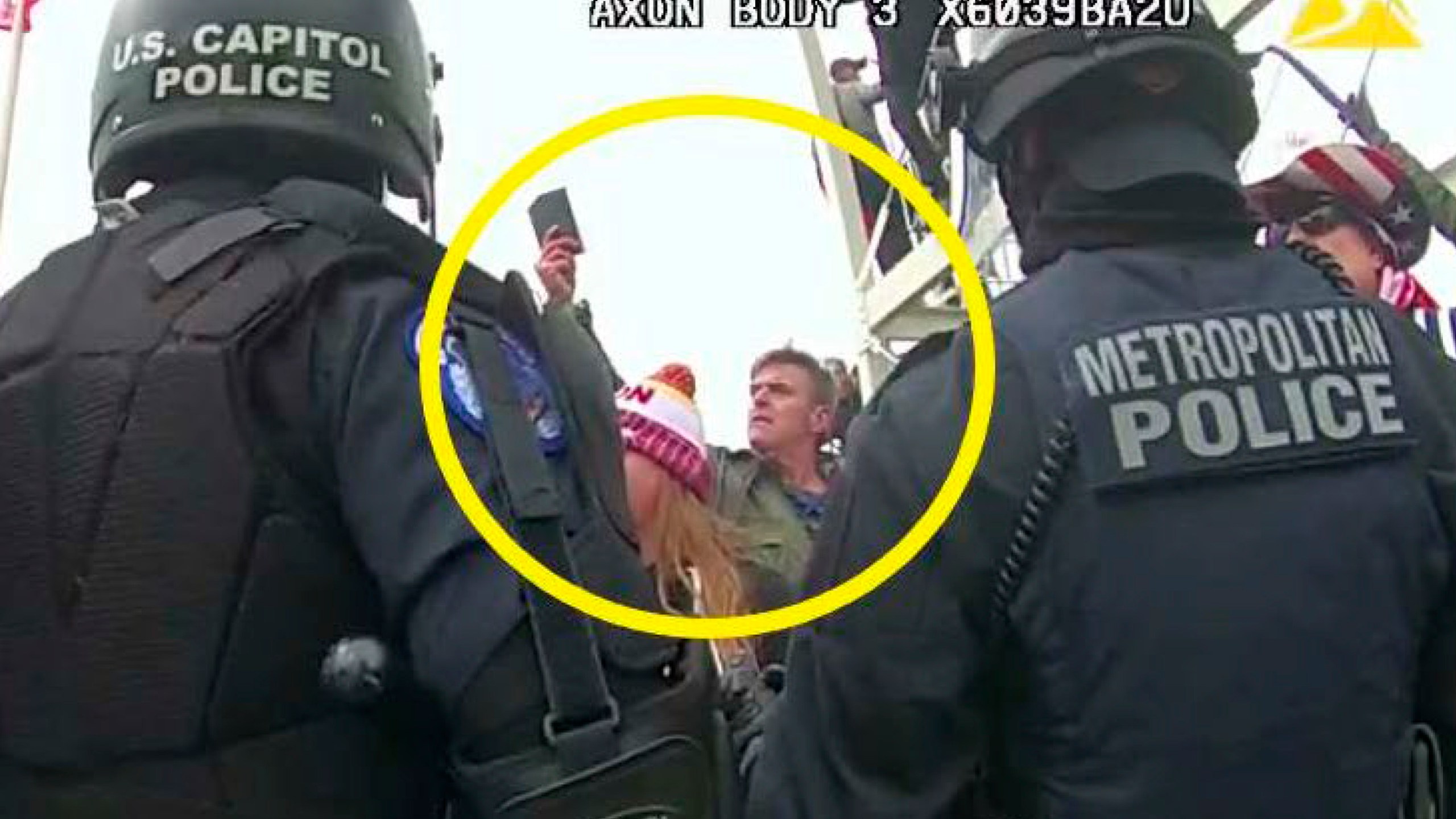 This image from Washington Metropolitan Police Department body-worn video, released and annotated by the Justice Department in the statement of facts supporting an arrest warrant for Jay James Johnston, shows Johnston, circled in yellow, at the U.S. Capitol on Jan. 6, 2021, in Washington. Johnston, the actor known for his roles on the comedy television shows "Bob's Burgers" and "Mr. Show with Bob and David" has been arrested on charges that he joined a mob of Donald Trump supporters in confronting police officers during the U.S. Capitol riot. (Justice Department via AP)