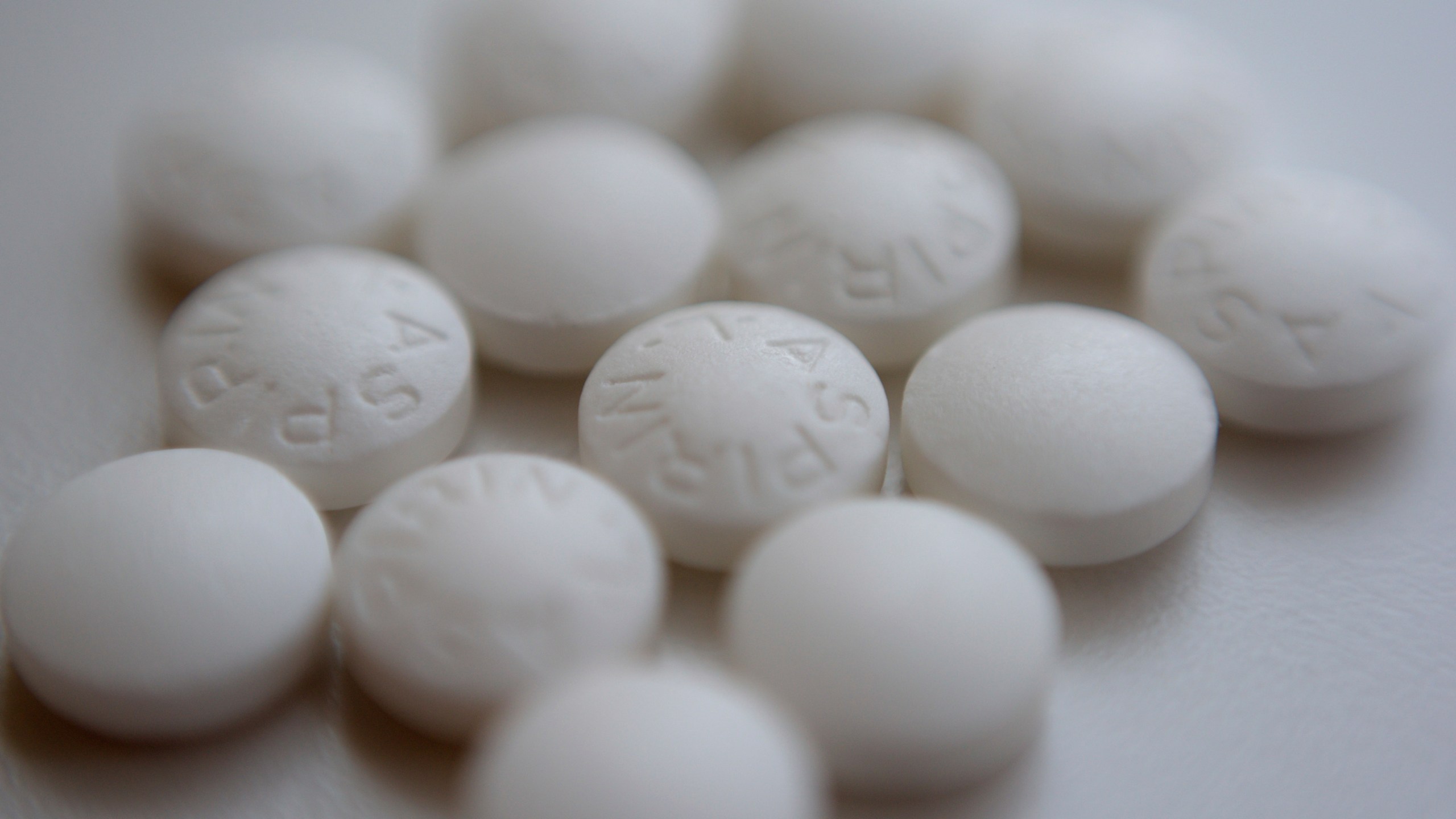 Photo shows an arrangement of aspirin pills.
