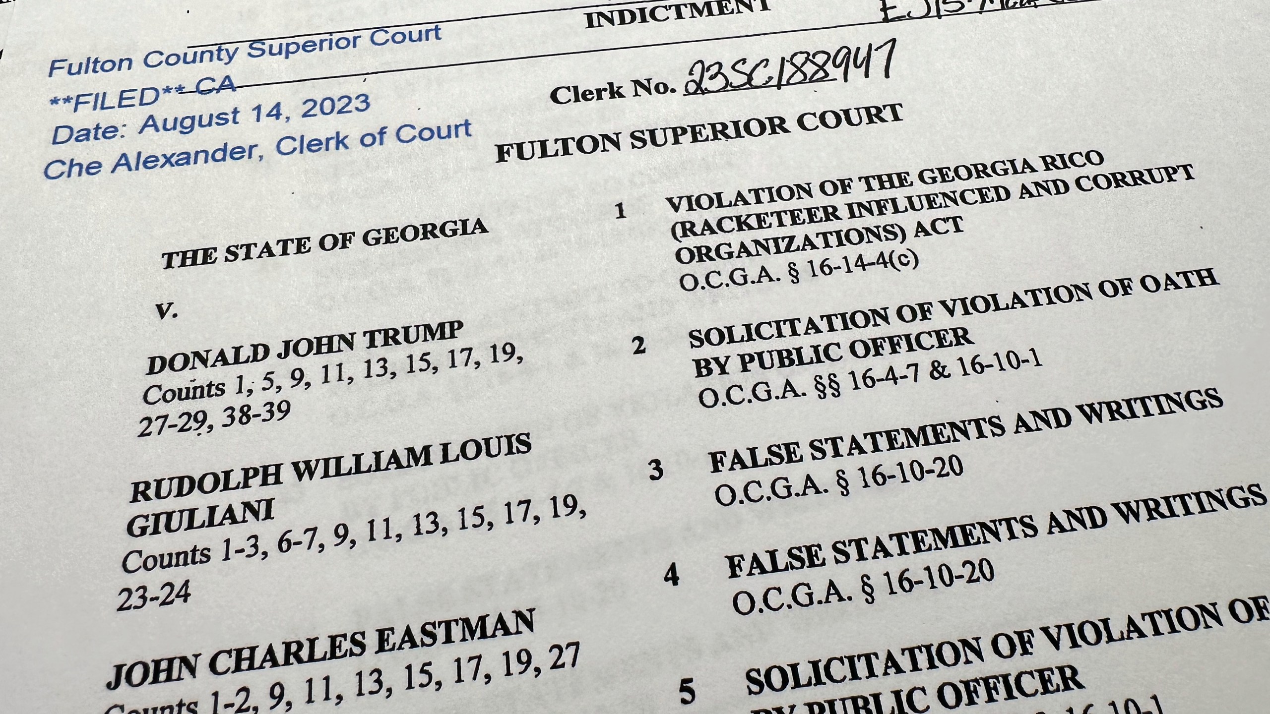 The indictment in Georgia against former President Donald Trump is photographed Monday, Aug. 14, 2023. (AP Photo/Jon Elswick)
