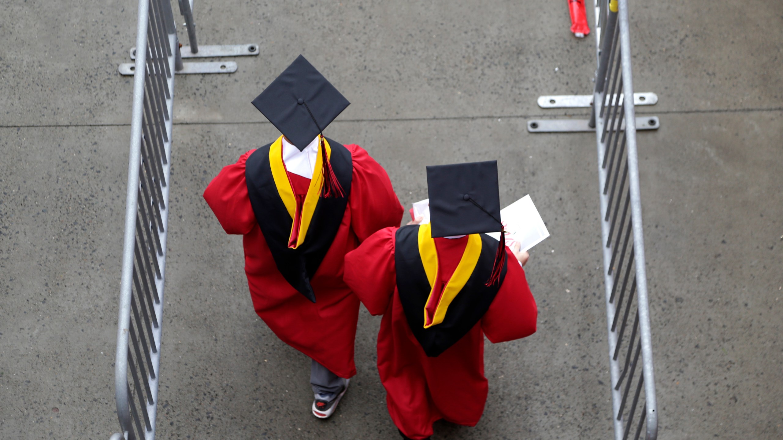 FILE - Graduates walk into High Point Solutions Stadium before the start of the Rutgers University graduation ceremony in Piscataway Township, N.J., on May 13, 2018. With the help of a nonprofit that focuses on civic education, the presidents of a wide-ranging group of 13 universities have decided to elevate free speech on their campuses this academic year. (AP Photo/Seth Wenig, File)