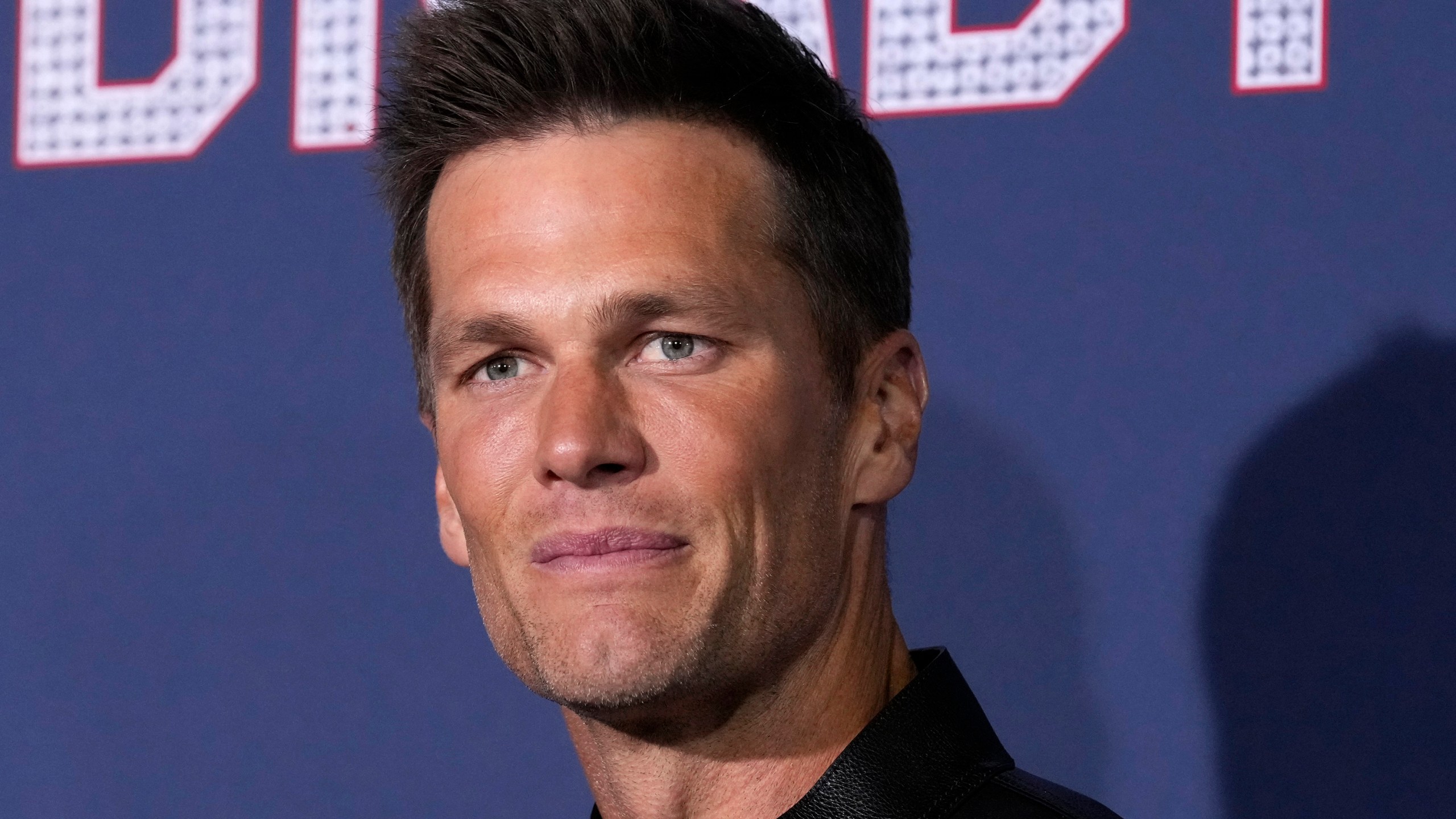 NFL quarterback Tom Brady poses at the premiere of the film "80 for Brady," Tuesday, Jan. 31, 2023, at the Regency Village Theatre in Los Angeles. Brady announced his retirement from the NFL on social media this morning.