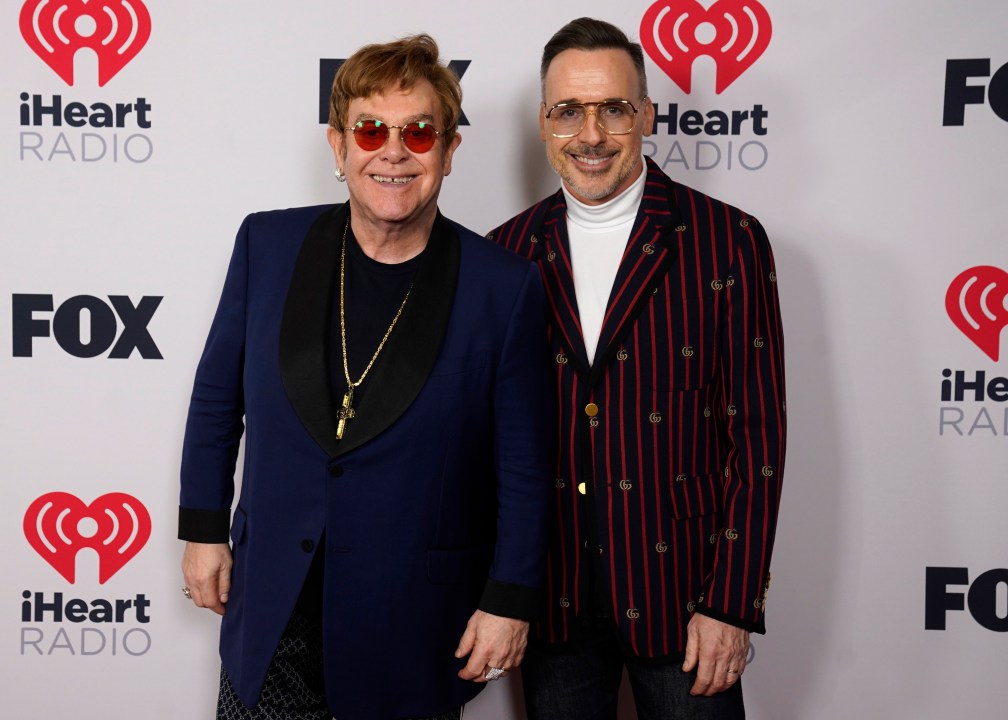 FILE - Icon award winner Elton John, left, and David Furnish attend the iHeartRadio Music Awards at the Dolby Theatre, May 27, 2021, in Los Angeles. Photos of iconic celebrities and historic moments from the collection of Elton John and David Furnish will go on display at London’s Victoria and Albert Museum next year. The museum said Tuesday Oct. 24, 2023, that the exhibition, titled “Fragile Beauty,” will include 300 images by more than 140 photographers, including Diane Arbus, Cindy Sherman, Robert Mapplethorpe, William Eggleston, Zanele Muholi and Ai Weiwei. (AP Photo/Chris Pizzello, File)