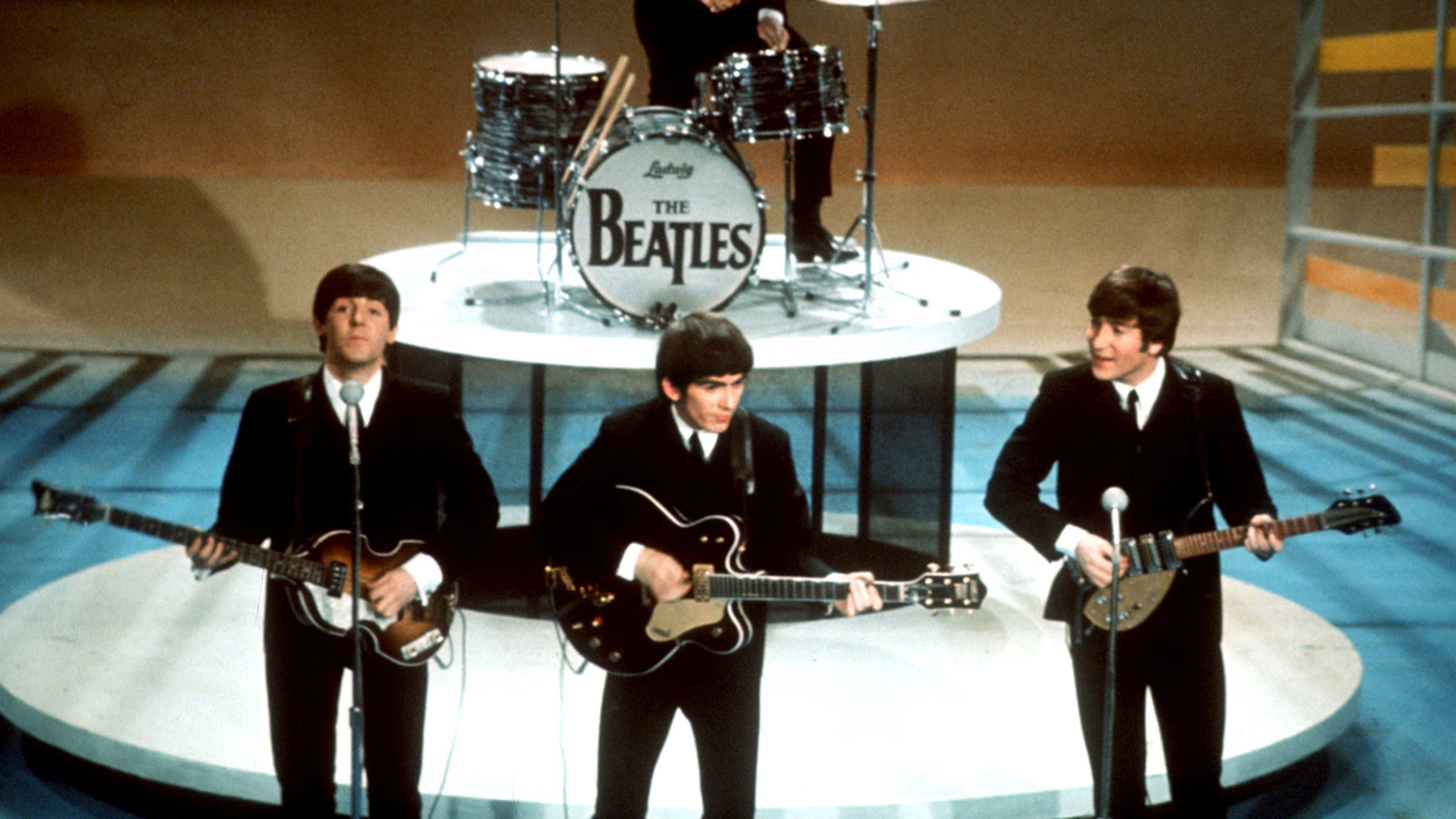 FILE -The Beatles, foreground from left, Paul McCartney, George Harrison, John Lennon and Ringo Starr on drums perform on the CBS "Ed Sullivan Show" in New York on Feb. 9, 1964. Sixty years after the onset of Beatlemania and with two of the quartet now dead, artificial intelligence has enabled the release of a “new” Beatles song.“Now And Then,” will be available Thursday, Nov. 2. (AP Photo/File)