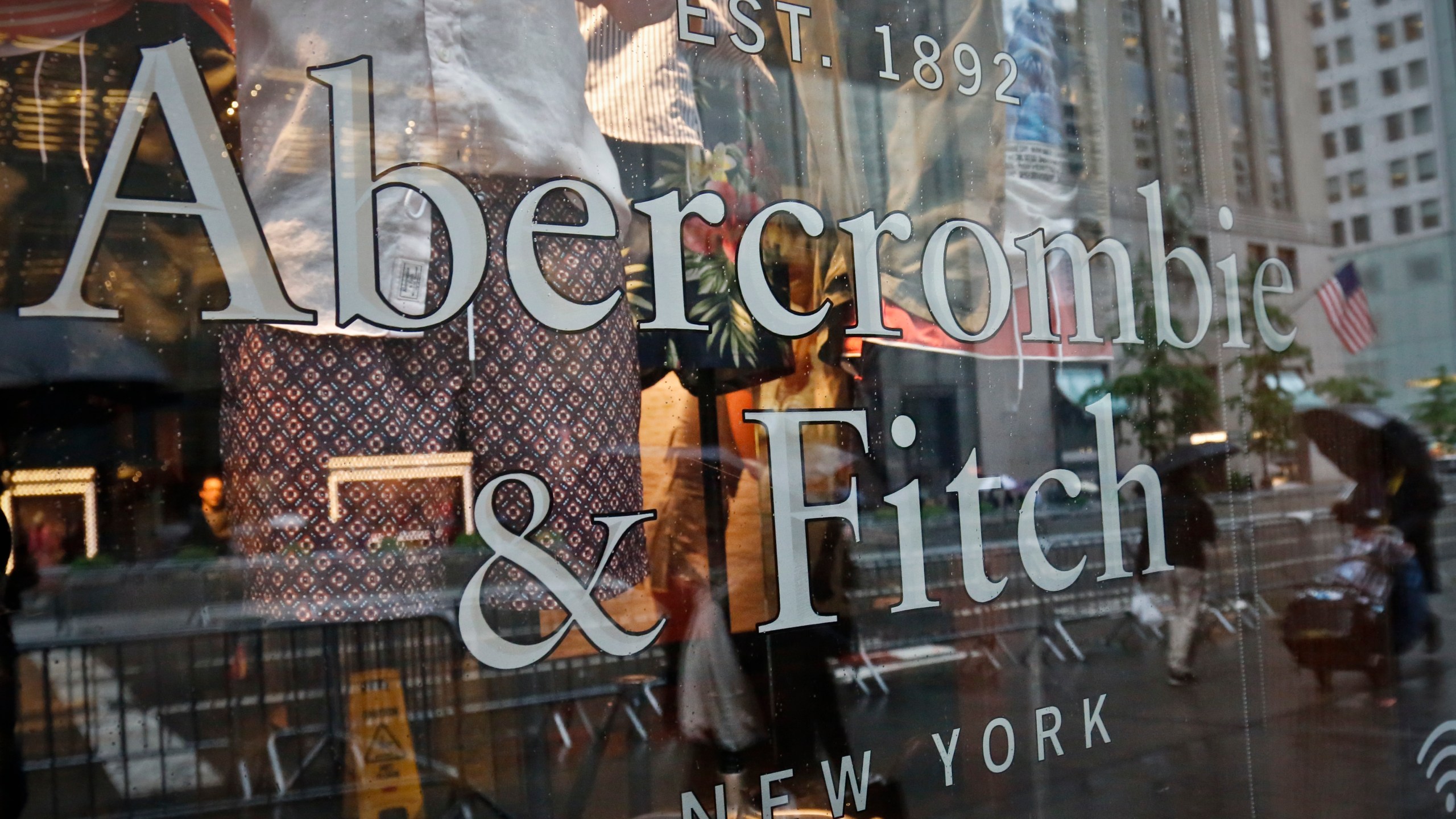 FILE - In this May 22, 2017, file photo, a store window reflects a street scene at an Abercrombie & Fitch store on New York's Fifth Avenue. A former model for Abercrombie & Fitch has sued the fashion retailer, Friday, Oct. 27, 2023, alleging it allowed its former CEO Mike Jeffries to run a sex-trafficking organization during his 22-year tenure.(AP Photo/Bebeto Matthews, File)