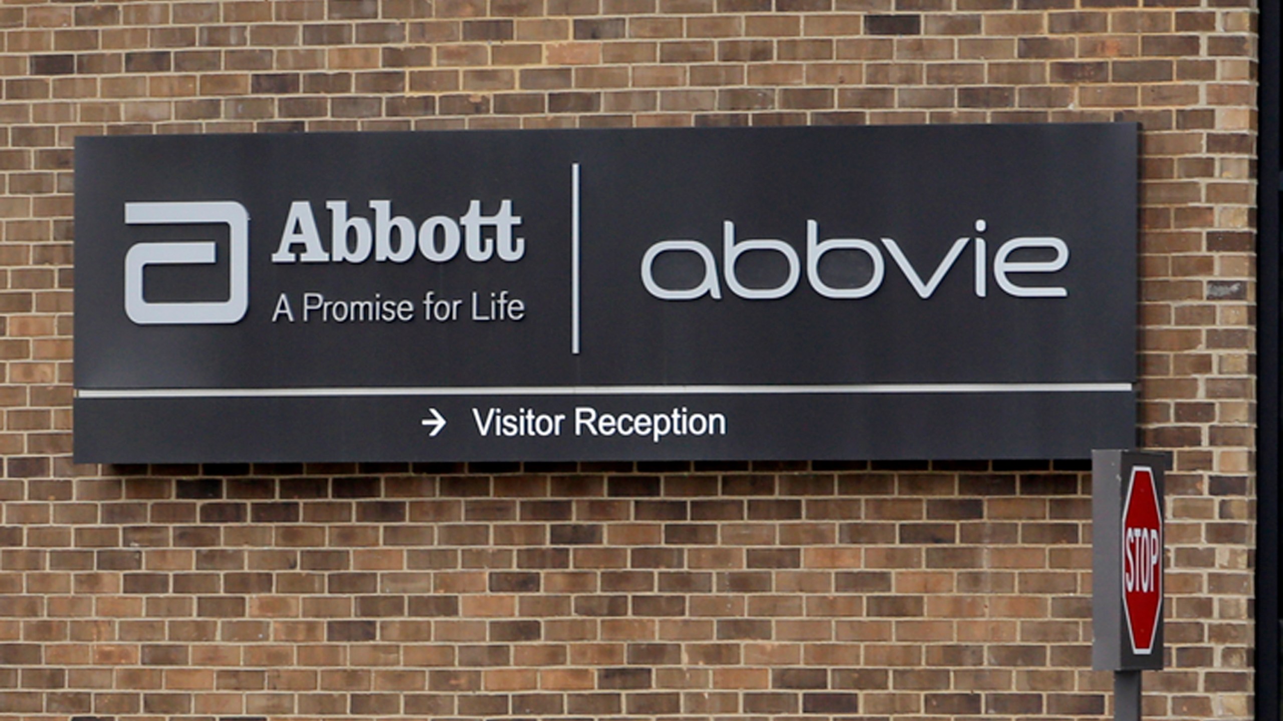 A photo of the Abbott and AbbVie logos.