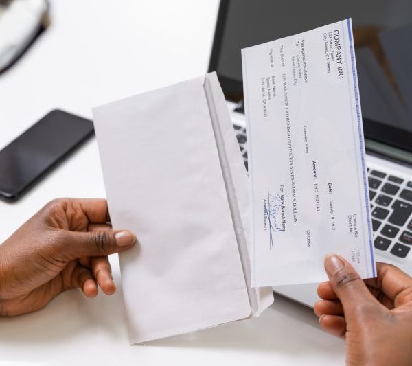 person holding paycheck