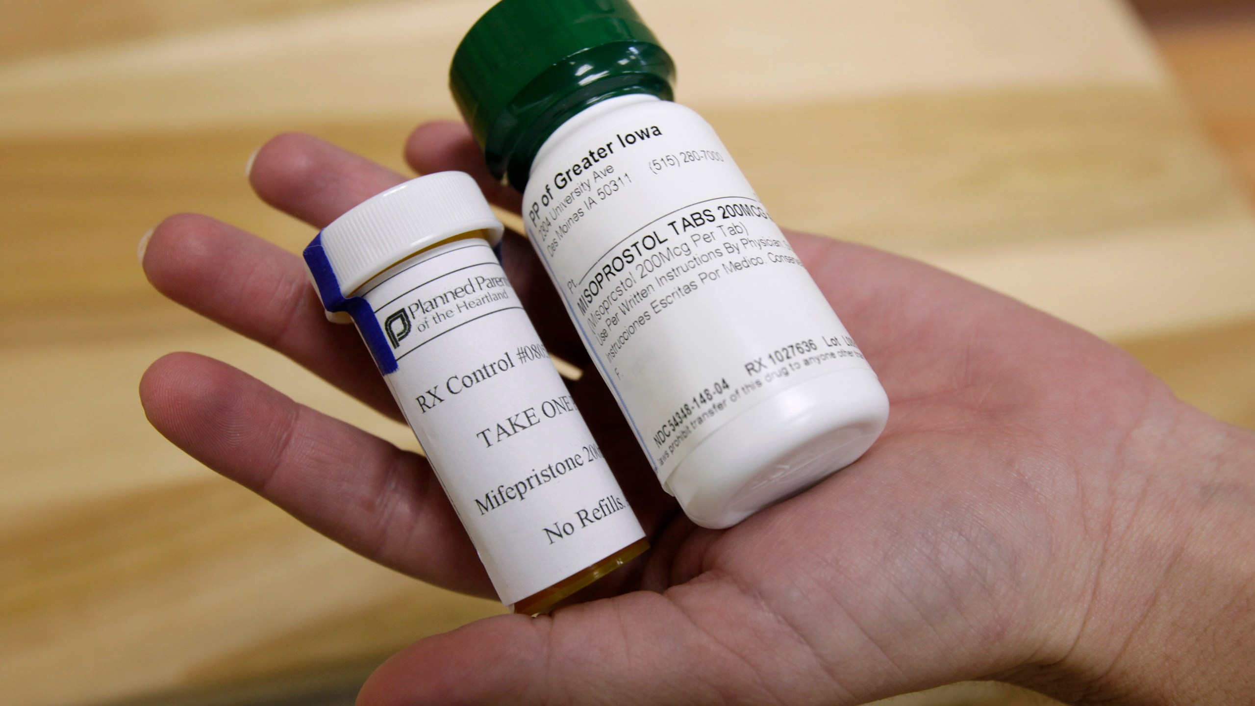FILE - Bottles of abortion pills mifepristone, left, and misoprostol, right, are shown, Sept. 22, 2010, at a clinic in Des Moines, Iowa. Thousands of women stocked up on abortion pills just in case they needed them, according to new research published Tuesday, Jan. 2, 2024, in JAMA Internal Medicine, with demand peaking in the past couple years at times when it looked like the medications might become harder to get. (AP Photo/Charlie Neibergall, File)