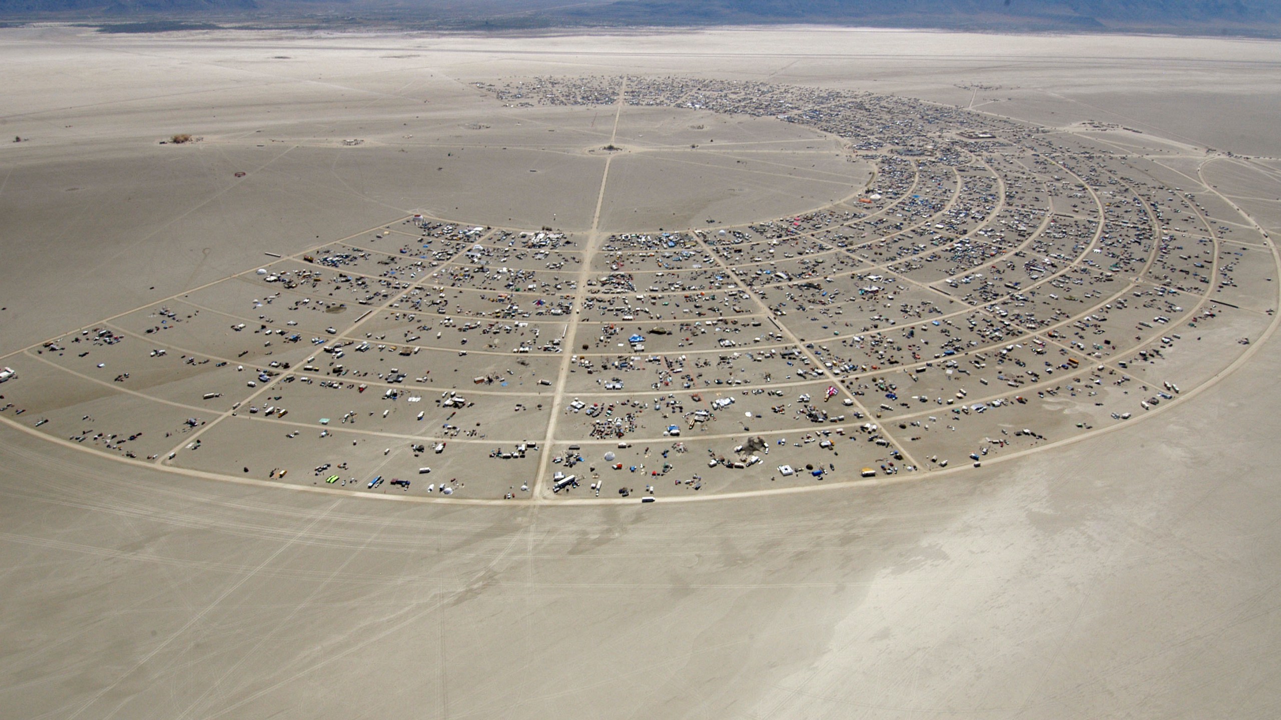 FILE - Black Rocky City begins to grow during the opening of Burning Man Sunday, Aug. 27, 2006, in Gerlach, Nev. Burning Man organizers don't foresee major changes in 2024 thanks to a hard-won passing grade for cleaning up this year's festival. Despite the successful inspection, debate continues over whether the 30-year-old gathering has grown too big. Some question whether it has veered too far from its core principles of radical inclusion and participation. (AP Photo/Ron Lewis, File)