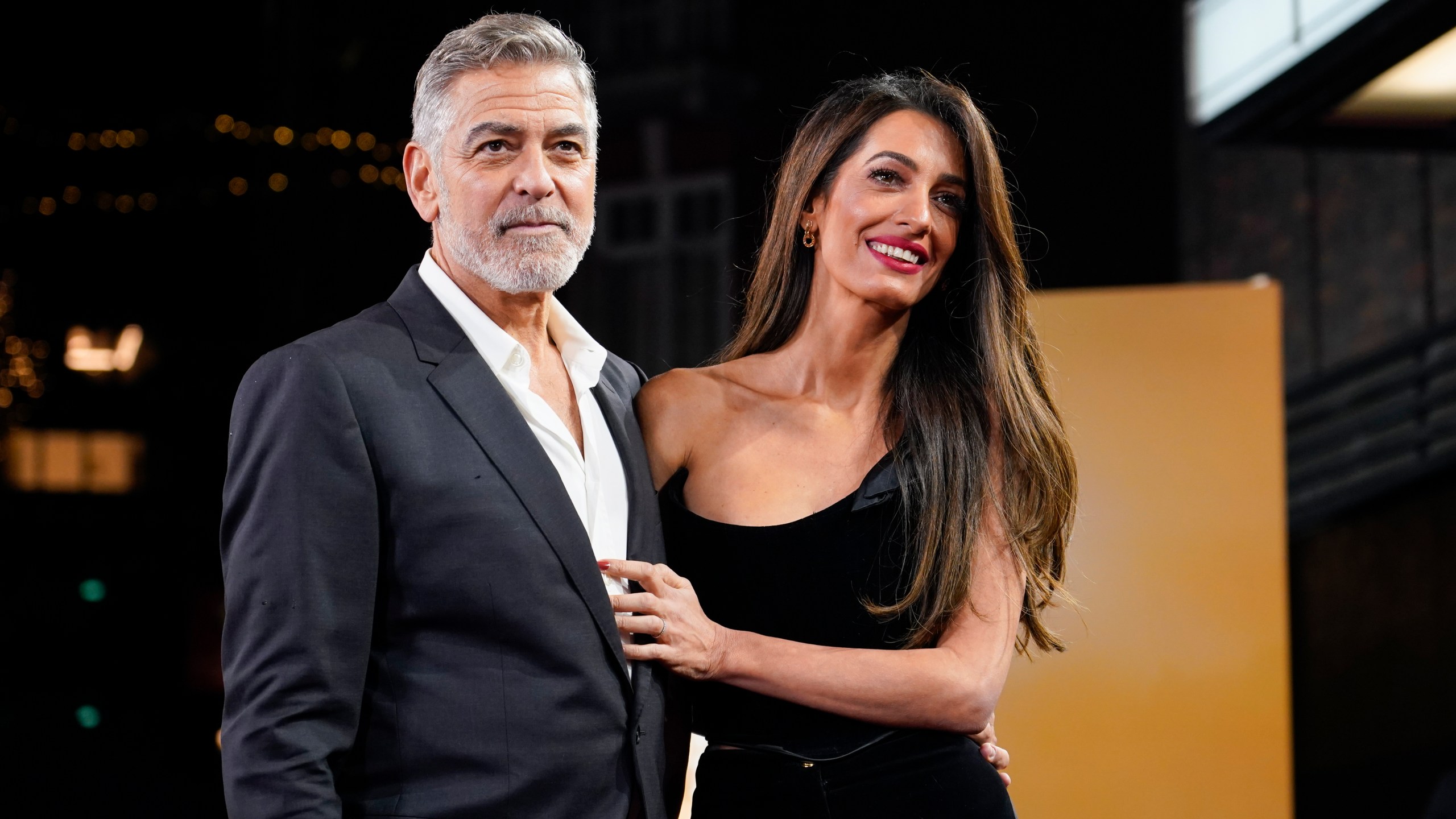 George and Amal Clooney pose for photos at an event