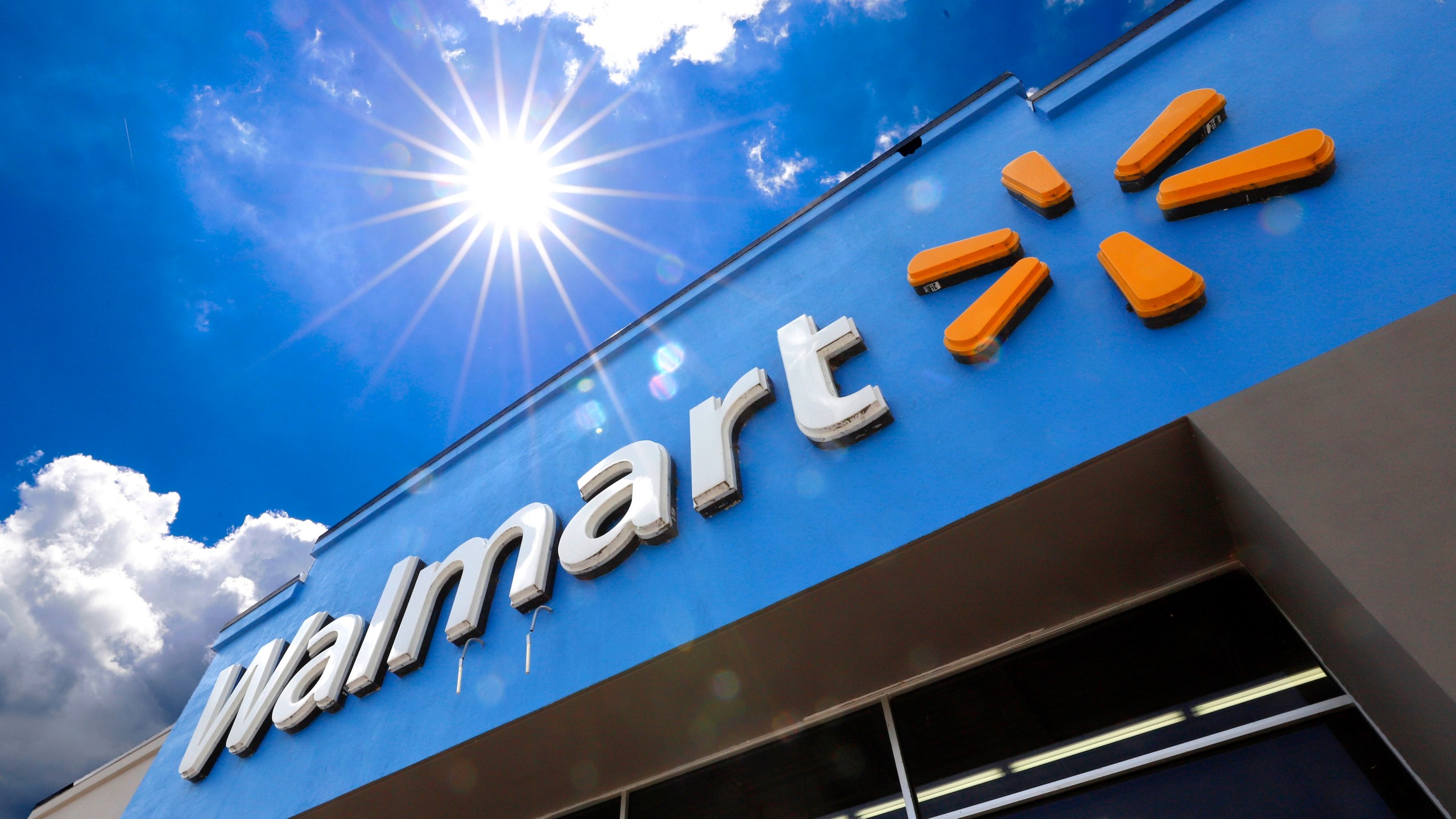 FILE - A Walmart sign is displayed over the entrance to a store on June 25, 2019 in Pittsburgh. Walmart is raising the starting base pay for store managers, while redesigning its bonus plan that will put more of an emphasis on profits for these leaders. The moves, announced Thursday, Jan. 18, 2024, will be effective Feb. 1. (AP Photo/Gene J. Puskar, File)