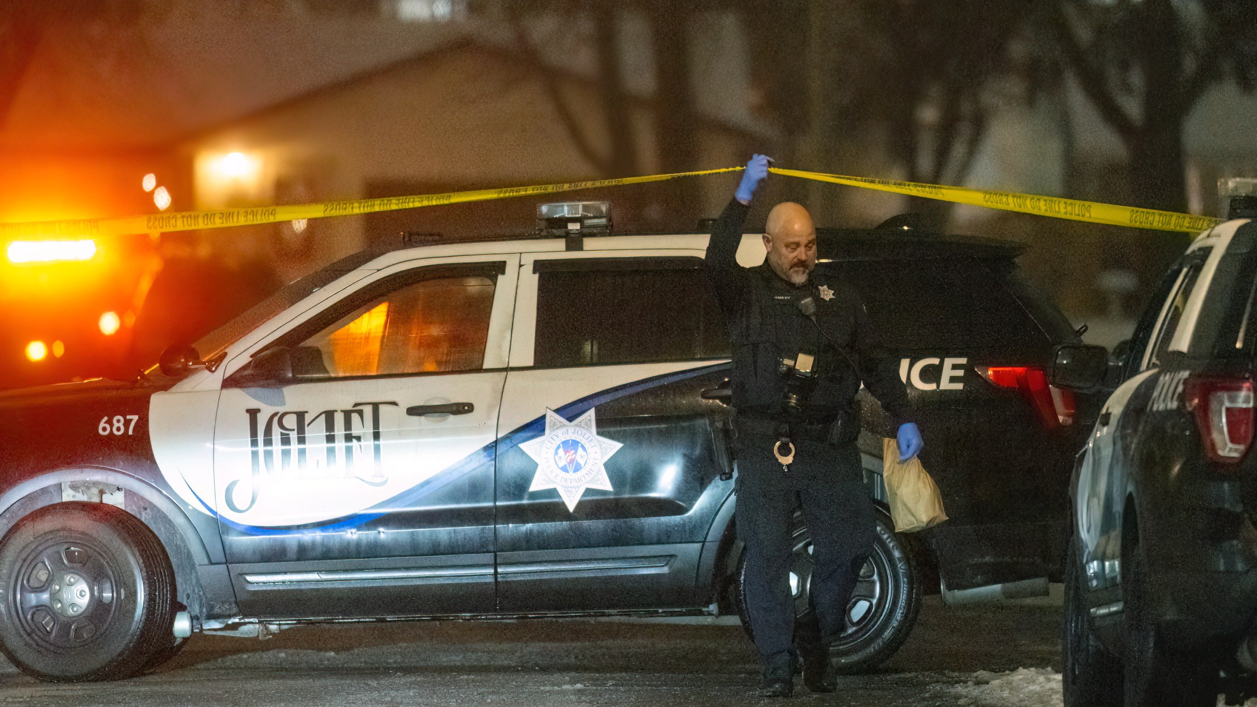 Police work a scene, Monday, Jan. 22, 2024, in Joliet, Ill., after multiple people were shot and killed over two days at three locations in the Chicago suburbs. (Tyler Pasciak LaRiviere/Chicago Sun-Times via AP)
