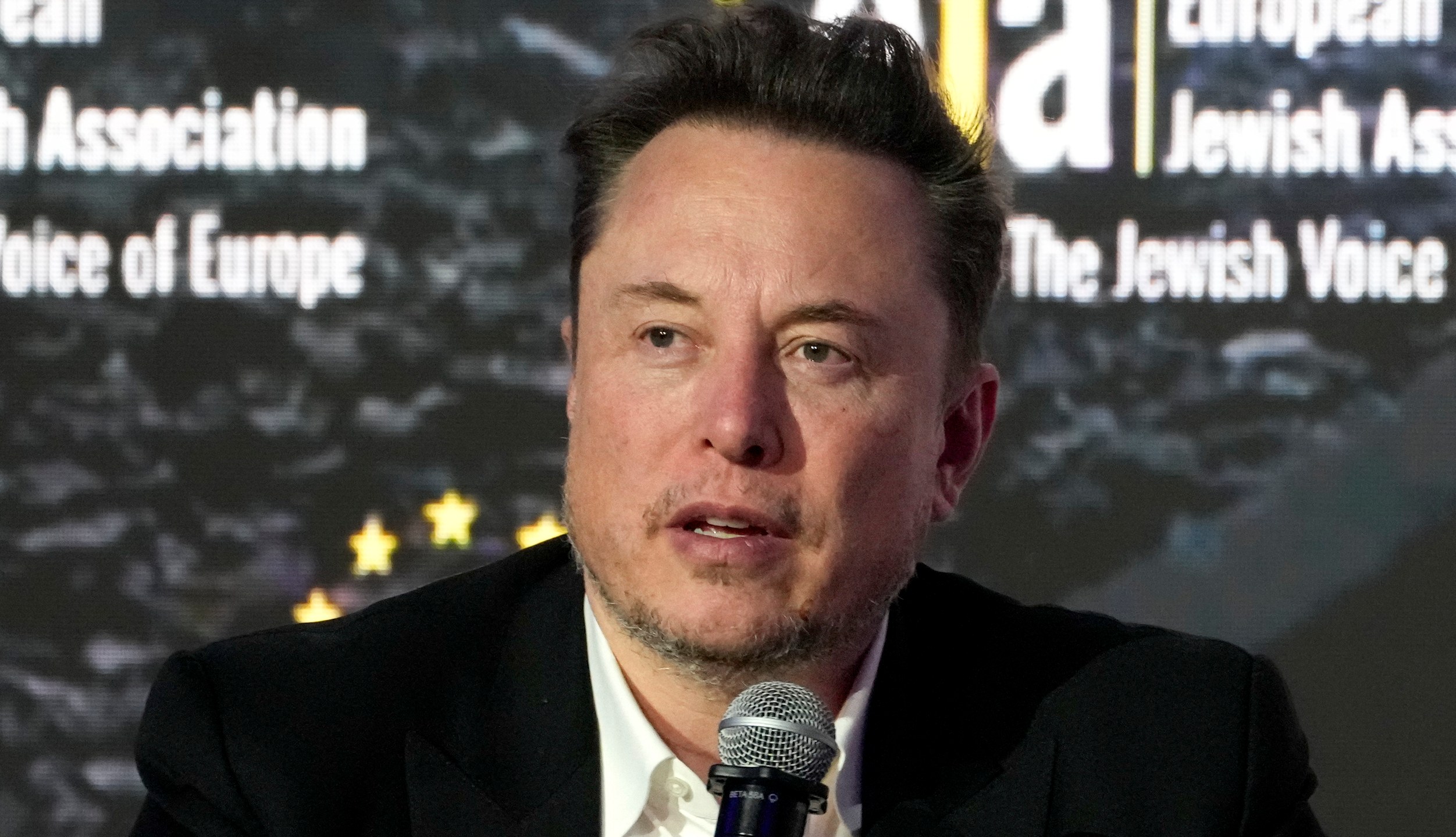 FILE - Tesla and SpaceX CEO Elon Musk addresses the European Jewish Association's conference, Jan. 22, 2024, in Krakow, Poland. Former senior executives of Twitter filed suit against Musk and X Corp. on Monday, March 4, saying they are entitled to more than $128 million total in unpaid severance payments. (AP Photo/Czarek Sokolowski, File)