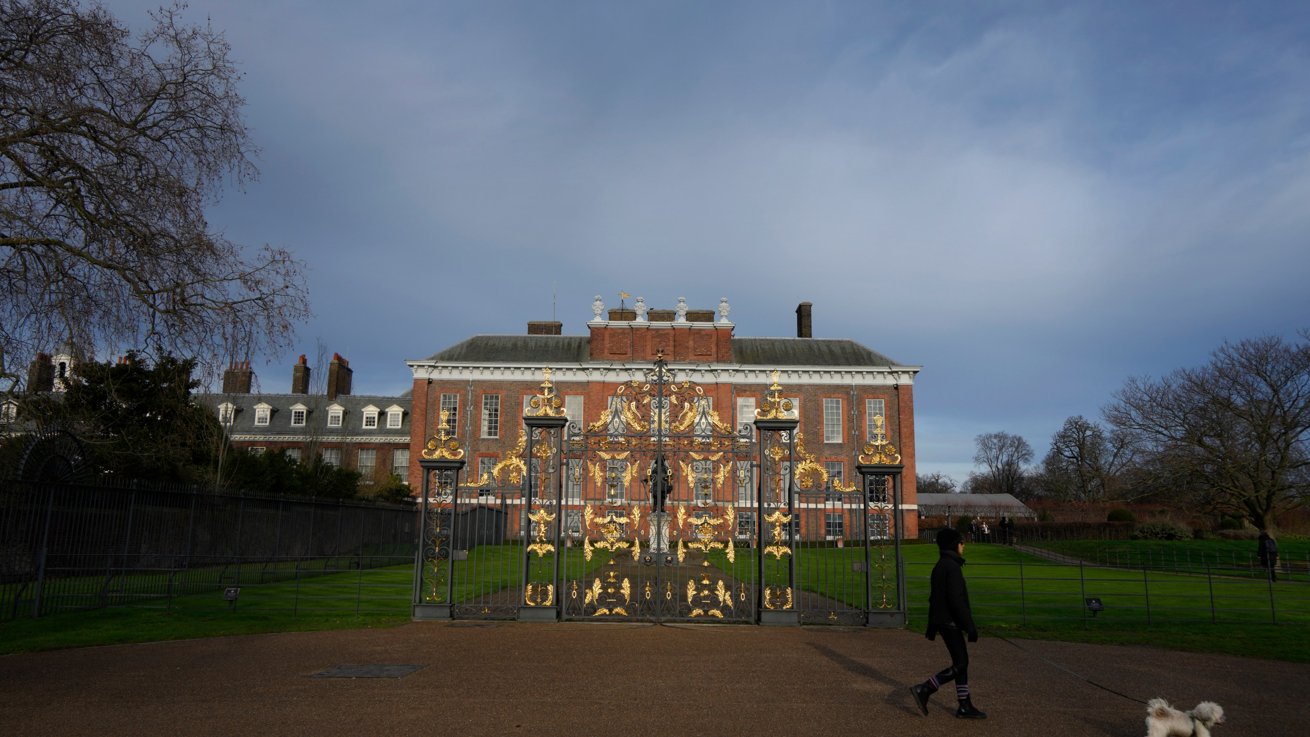 FILE - A dog walker passes Kensington Palace in London, Friday, Jan. 6, 2023. The first official photo of Kate, the Princess of Wales, since she underwent abdominal surgery nearly two months earlier, was pulled from circulation by The Associated Press and several other news organizations, Sunday, March 10, 2024, because the image appeared to have been manipulated. (AP Photo/Kirsty Wigglesworth, File)