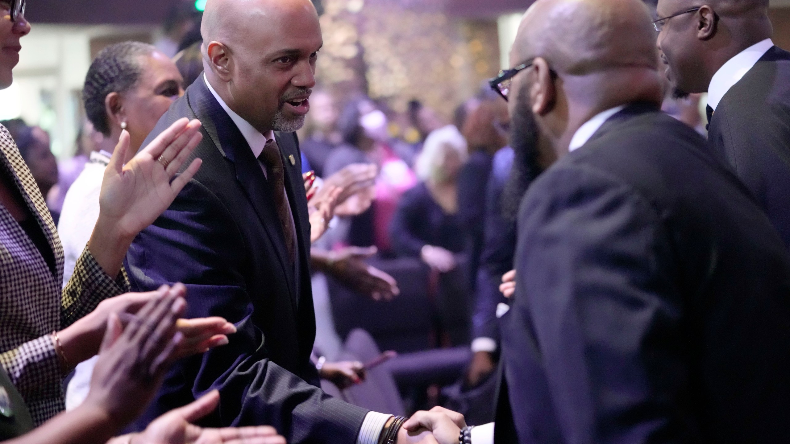 Clayton Harris, candidate for Cook county state's attorney, greets church members at Fellowship Baptist church in Chicago, Sunday, March 3, 2024. An open seat to lead the nation's second-largest prosecutor's office has become one of the most spirited races in the Illinois primary. The Democratic matchup is between O'Neill Burke, a tough-on-crime judge and Clayton Harris III, an attorney with union and establishment backing. (AP Photo/Nam Y. Huh)