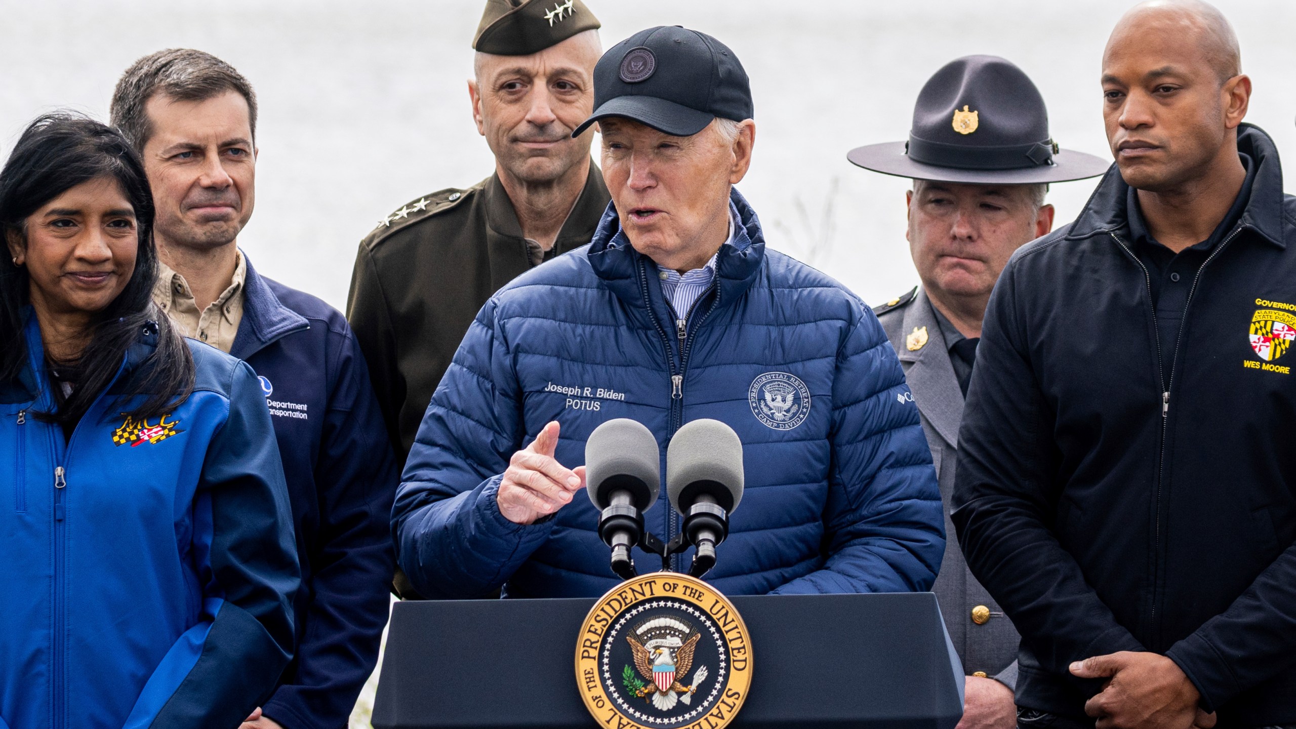 President Joe Biden speaks as Maryland Gov. Wes Moore, right, listens after an operational briefing on the response and recovery efforts of the collapsed Francis Scott Key Bridge, Friday, April 5, 2024, in Dundalk, Md. Looking on at second left is Transportation Secretary Pete Buttigieg. (AP Photo/Julia Nikhinson)