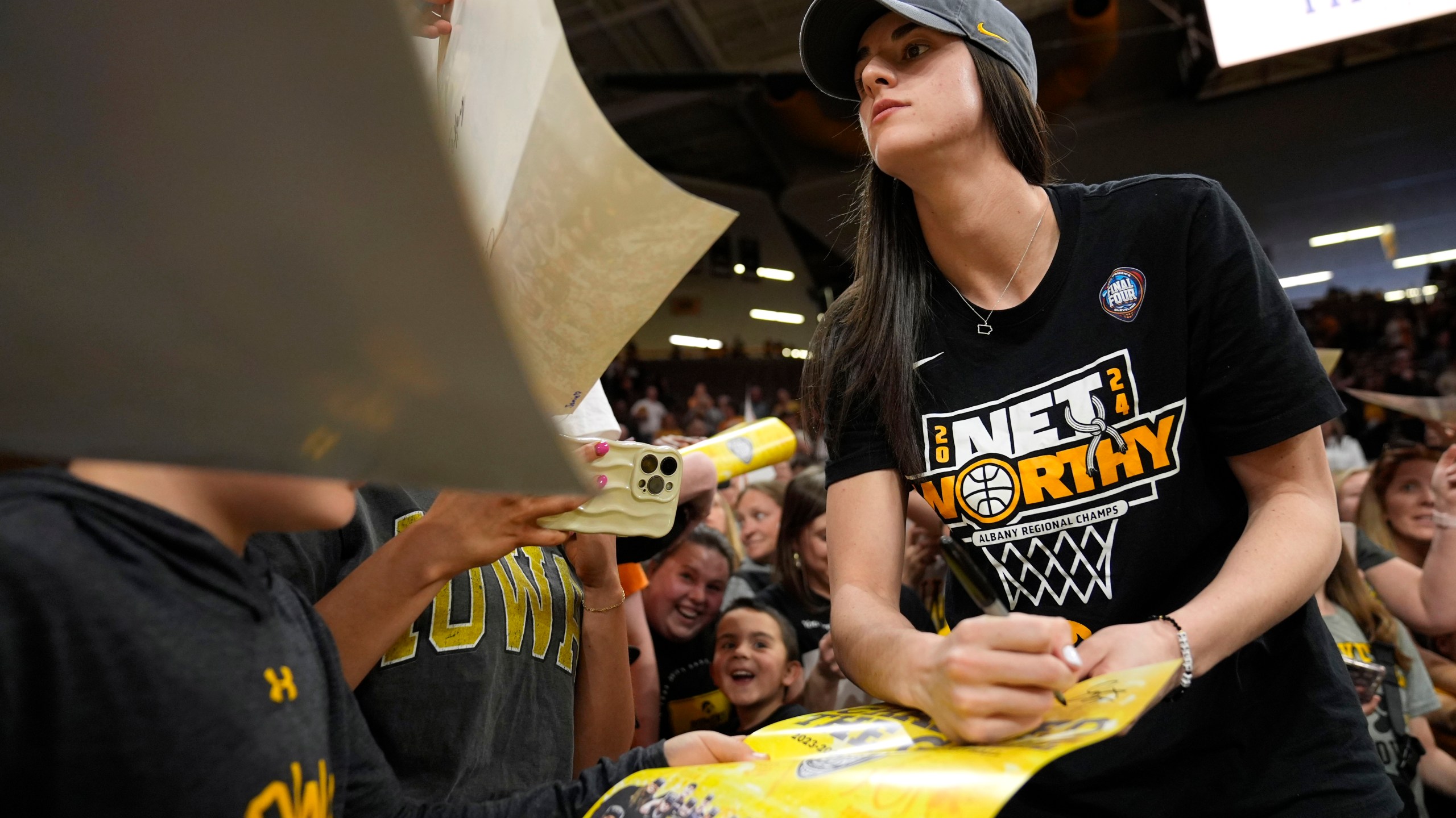Iowa guard Caitlin Clark signs autographs during an Iowa women's basketball team celebration, Wednesday, April 10, 2024, in Iowa City, Iowa. Iowa lost to South Carolina in the Final Four college basketball championship game of the women's NCAA Tournament on Sunday. (AP Photo/Charlie Neibergall)