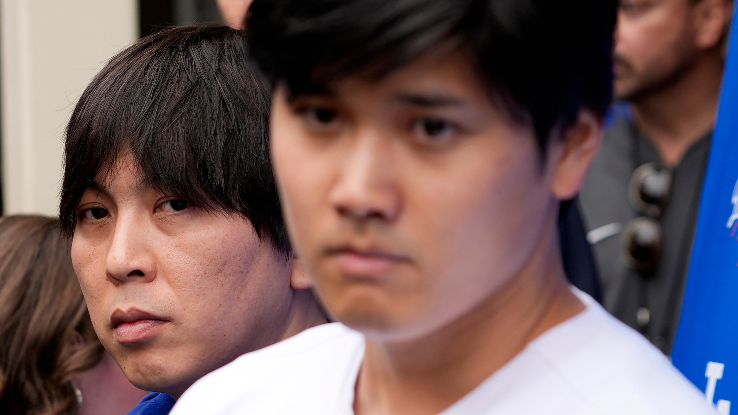 FILE - Interpreter Ippei Mizuhara stands next to Japanese baseball star Shohei Ohtani and translates during an interview at Dodger Stadium on Feb. 3, 2024, in Los Angeles. Mizuhara, the former interpreter for Ohtani pleaded guilty to bank and tax fraud Wednesday, May 8, 2024, in a sports betting case where prosecutors allege he stole $16 million from the Japanese baseball player to pay off debts. (AP Photo/Richard Vogel, File)