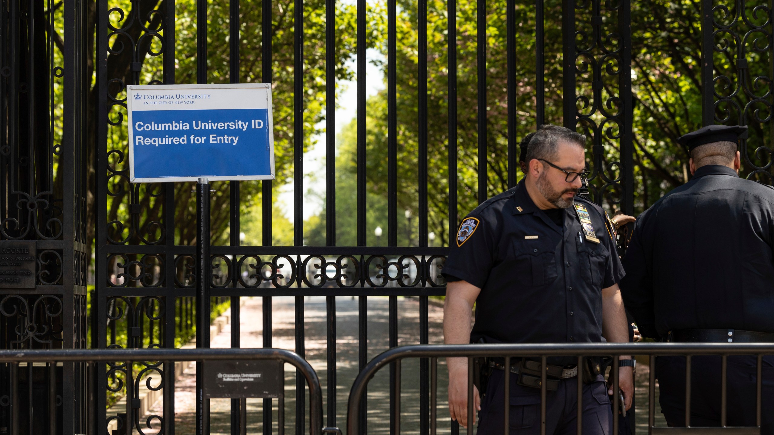 FILE - Police officers stand guard outside Columbia University, Thursday, May 2, 2024, in New York. Colleges and universities have long been protected places for free expression without pressure or punishment. But protests over Israel's conduct of the war in Gaza in its hunt for Hamas after the Oct. 7 massacre has tested that ideal around the world. (AP Photo/Yuki Iwamura, File)