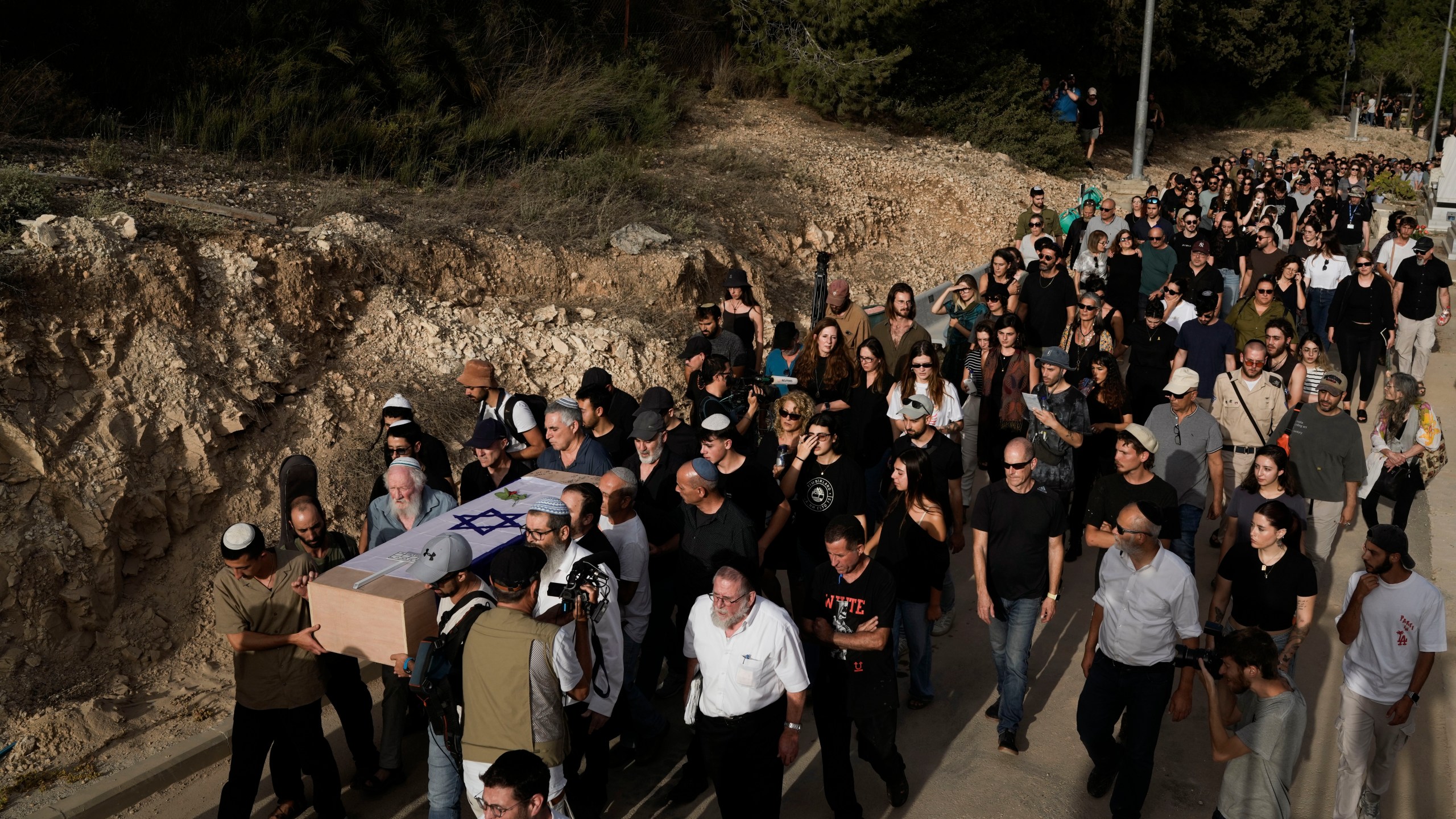 Mourners carry the flag-covered coffin of Shani Louk during her funeral in Srigim, Israel, on Sunday, May 19, 2024. Louk, a 22-year-old German-Israeli, was killed while fleeing a music festival during Hamas' Oct. 7 attack and her body was taken into Gaza. Israeli forces recovered her remains last week along with those of three other Israelis killed during the attack, which ignited the war in Gaza. (AP Photo/Leo Correa)