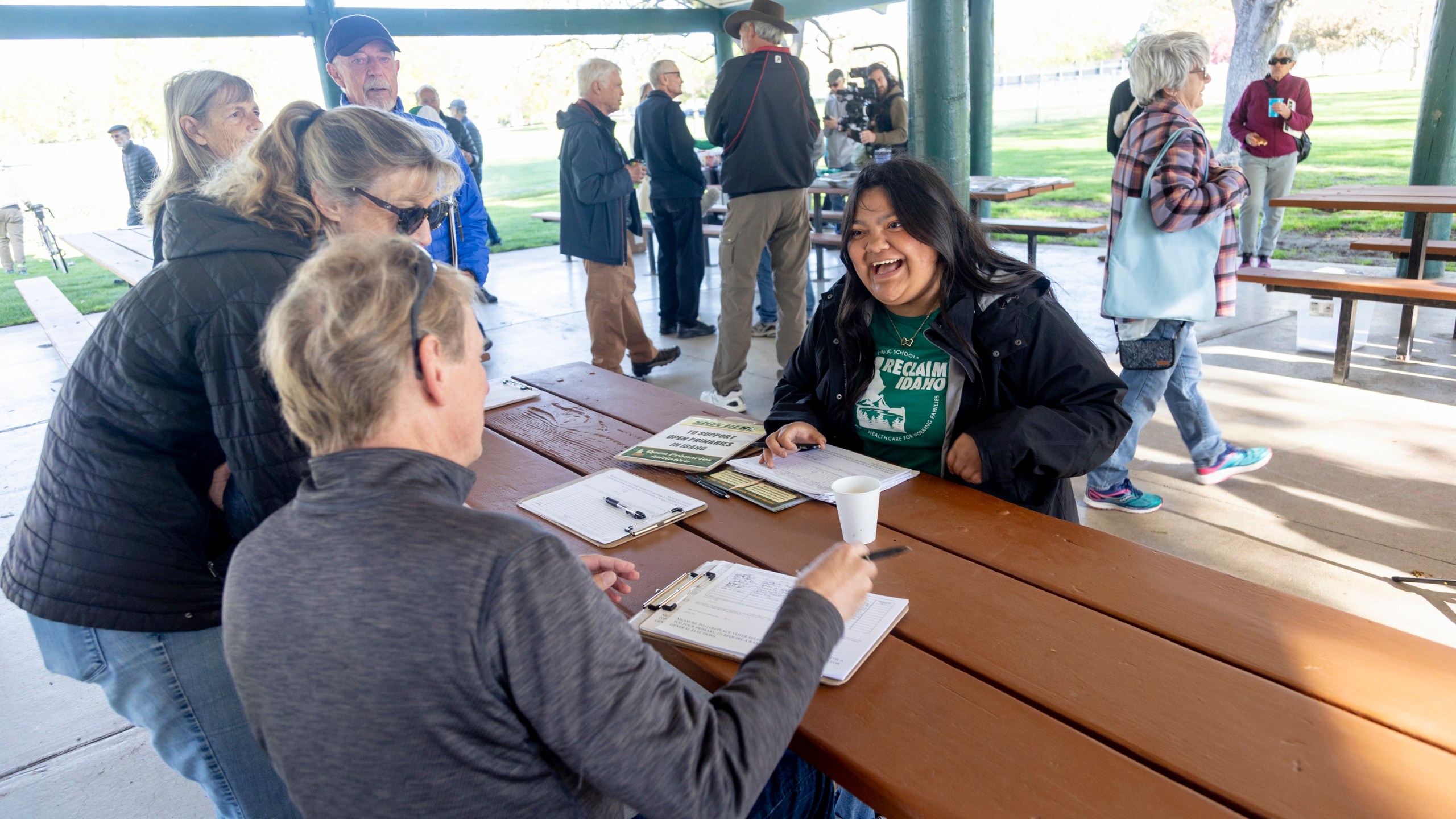 Olivia Luna, right, statewide field fellow for Idahoans for Open Primaries talks with volunteers supporting the Idaho open primaries ballot initiative during a gathering at Ivywild Park in Boise, Idaho on April 27, 2024. Idahoans for Open Primaries has been collecting signatures to get open primaries and ranked choice voting on the November ballot, which they say will open Idaho's closed primary system that excludes 270,000 people who consider themselves Independents. (AP Photo/Kyle Green)
