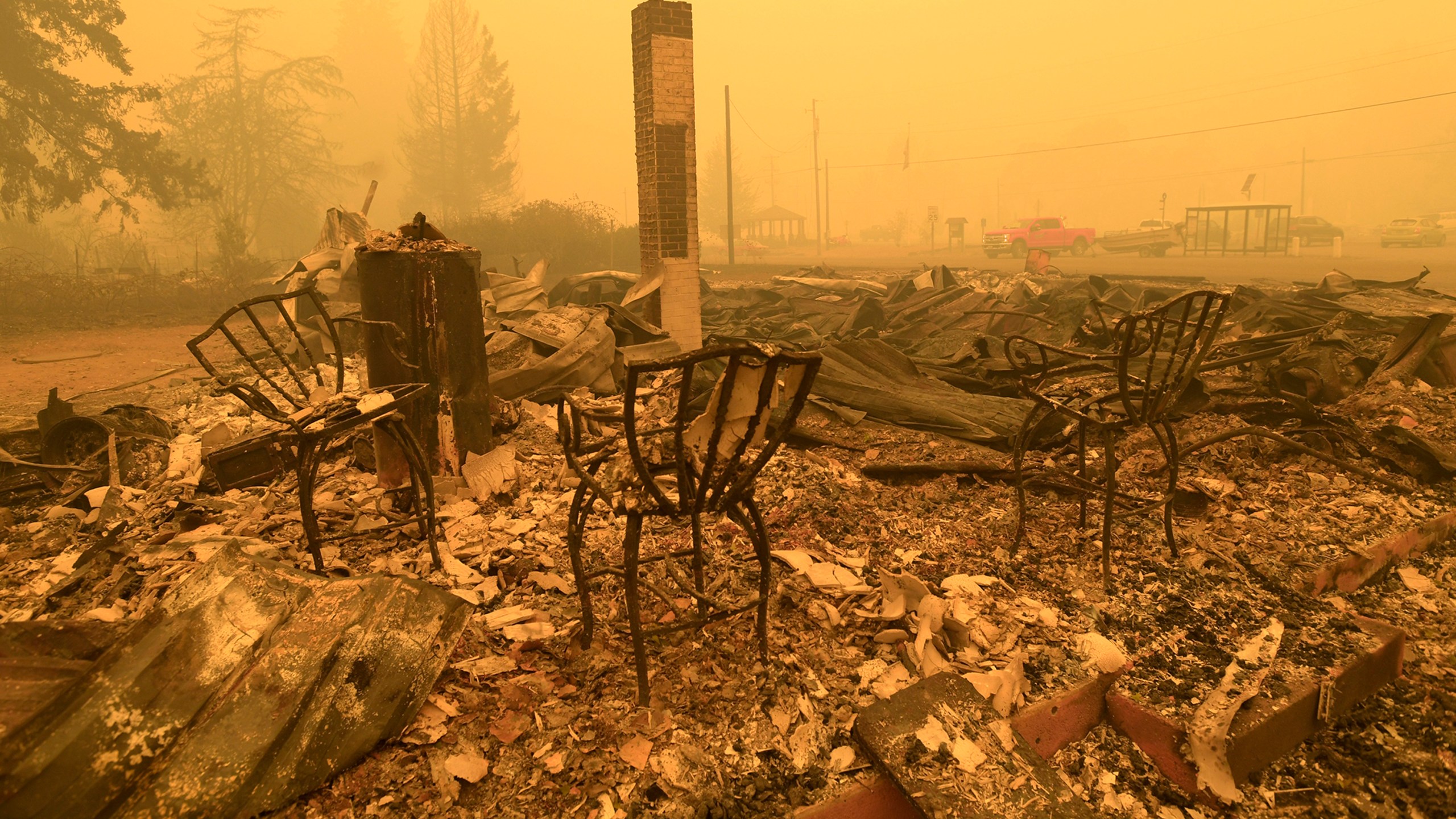 FILE - Chairs stand at the Gates Post office in the aftermath of a fire in Gates, Ore., Sept 9, 2020. The post office was destroyed along with several other buildings in the Santiam Canyon community as a result of the Santiam Fire. Pacific Power, owned by PacifiCorp, said Monday, June 3, 2024, that it has agreed to a nearly $180 million settlement with over 400 Oregon plaintiffs who sued the utility after the deadly 2020 wildfires. (Mark Ylen/Albany Democrat-Herald via AP, File)