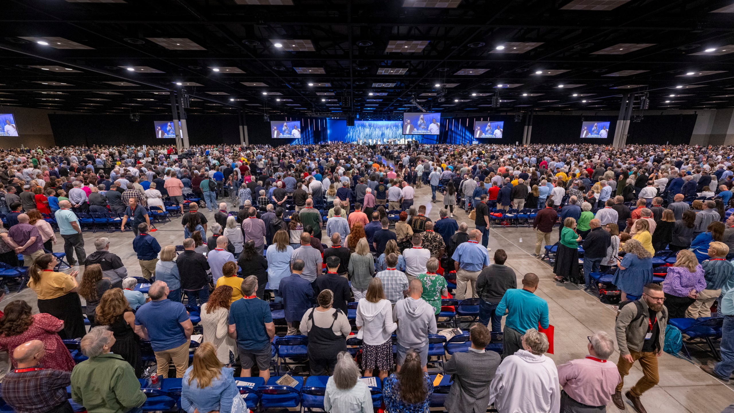 Messengers stand for worship during a Southern Baptist Convention annual meeting Tuesday, June 11, 2024, in Indianapolis. (AP Photo/Doug McSchooler)
