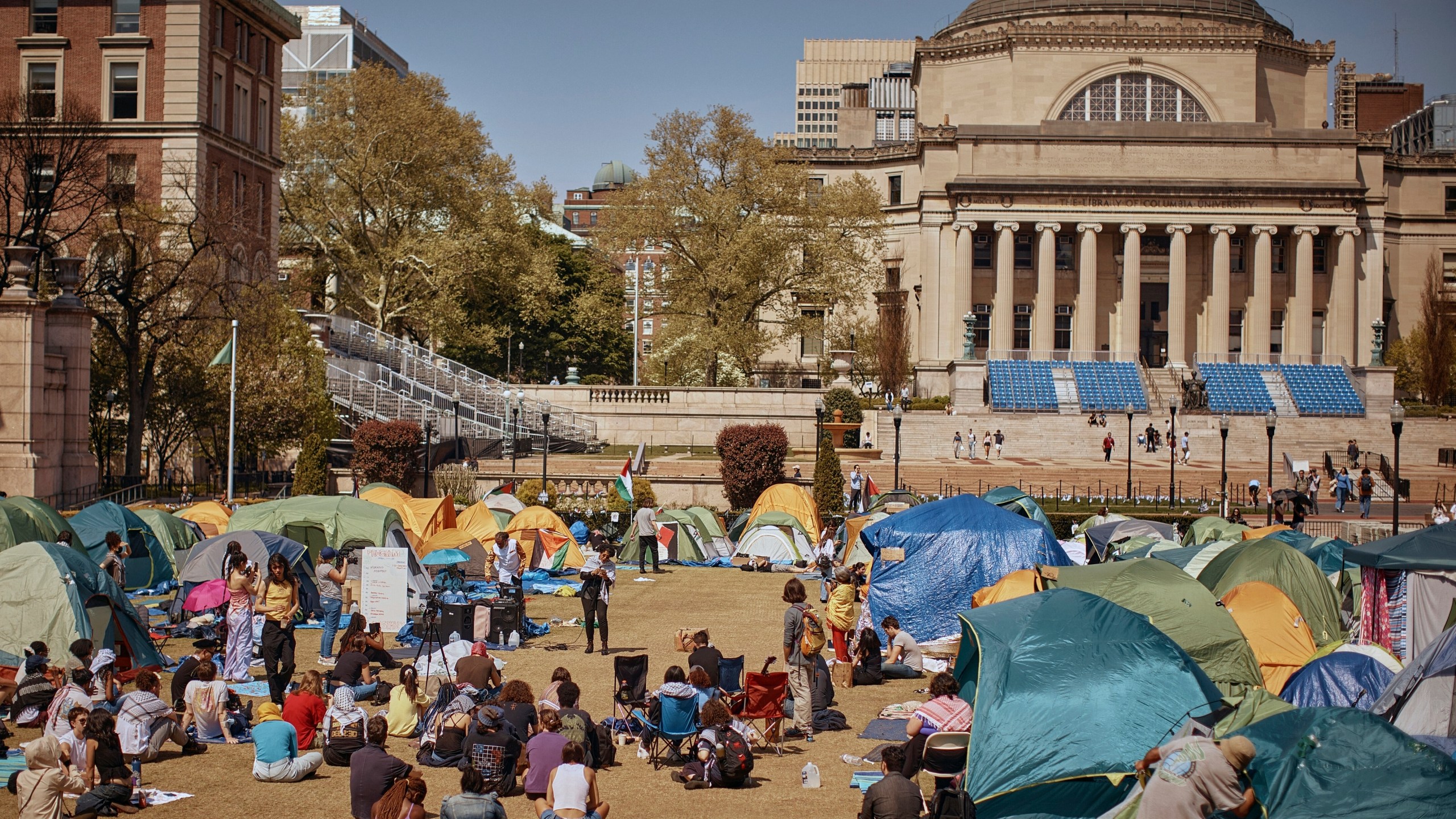 People listen to a speaker at a pro-Palestinian encampment at Columbia University calling for a permanent cease-fire in Gaza.