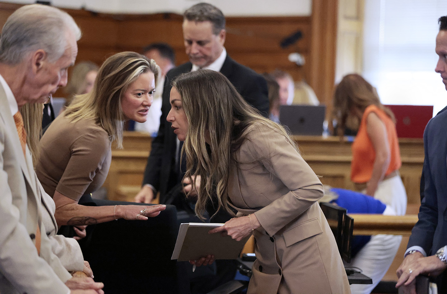 Karen Read listens to family members, after the jury is dismissed at the end of the evidence phase of her murder trial at Norfolk Superior Court, in Dedham, Mass., Monday, June 24, 2024. Read is accused of backing her SUV into her Boston Police officer boyfriend, John O'Keefe, and leaving him to die in a blizzard in Canton, in 2022. (Pat Greenhouse/The Boston Globe via AP, Pool)
