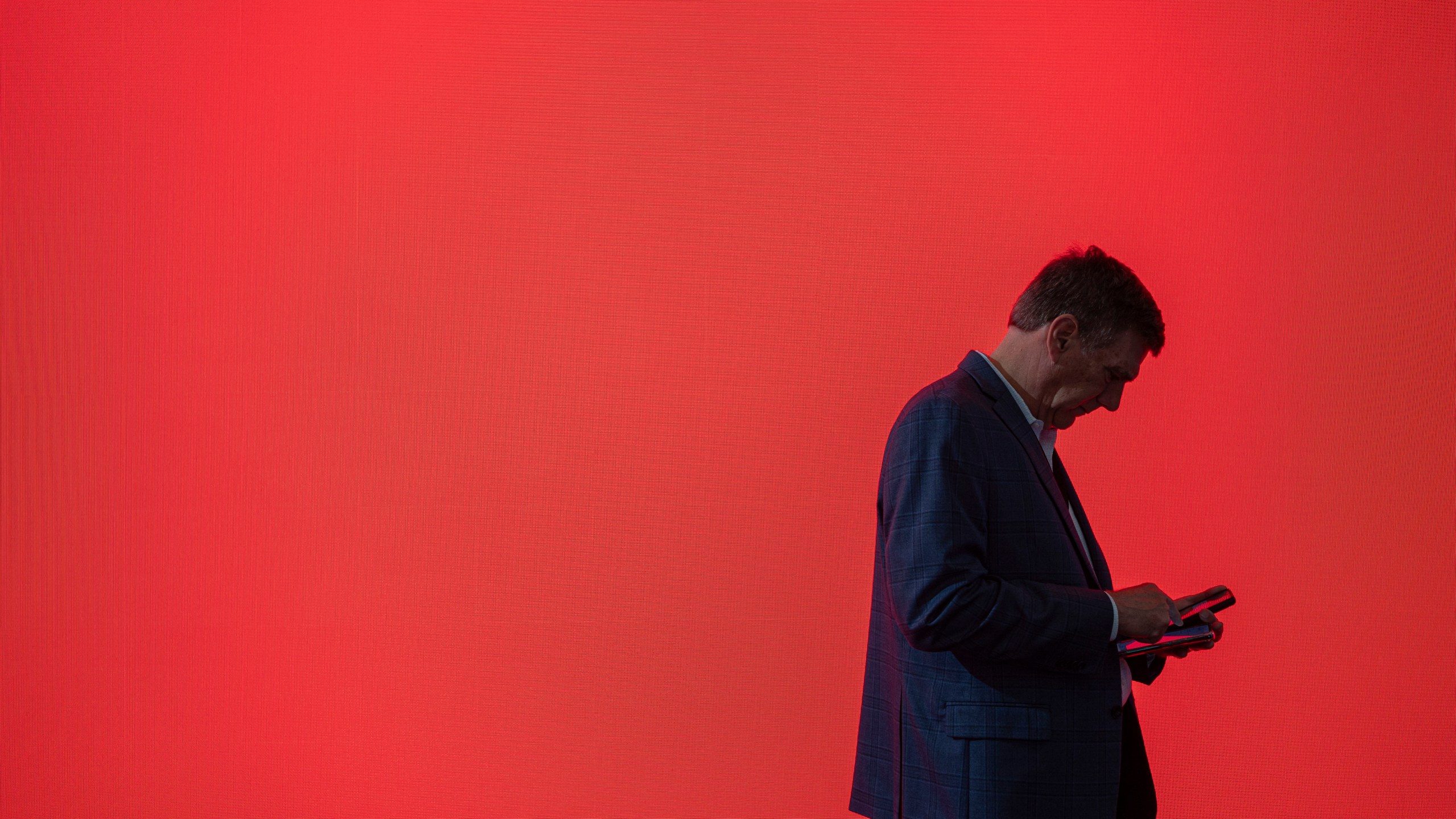 FILE - A visitor looks at his phone at the Mobile World Congress 2024 in Barcelona, Spain, Feb. 27, 2024. According to some un-scientific studies, the average person has hundreds of passwords to their name. (AP Photo/Pau Venteo, File)