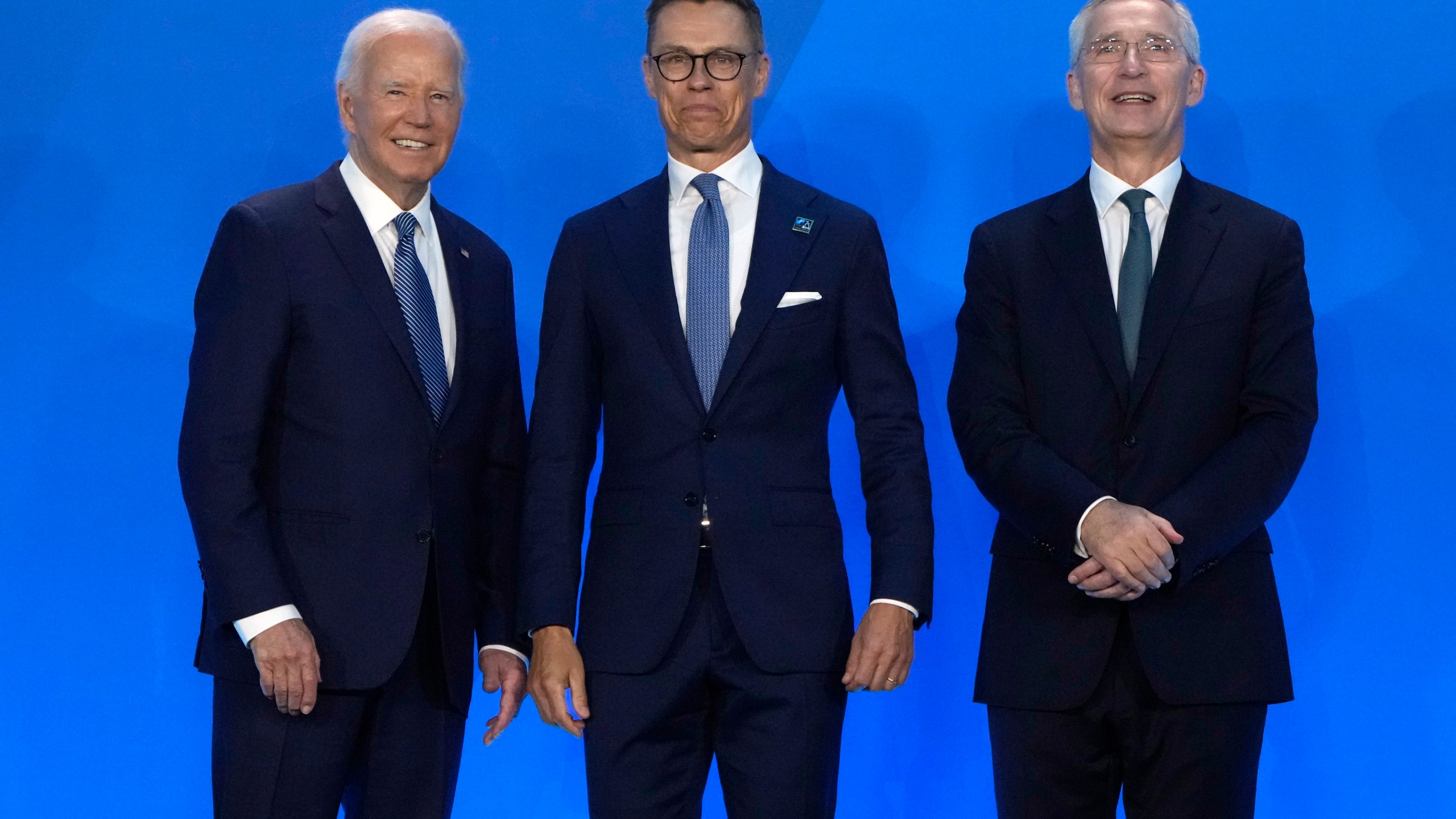 President Joe Biden, left, and NATO Secretary General Jens Stoltenberg, right, greet Alexander Stubb, President of Finland, as they arrive for a welcome ceremony at the NATO summit in Washington, Wednesday, July 10, 2024. (AP Photo/Mark Schiefelbein)