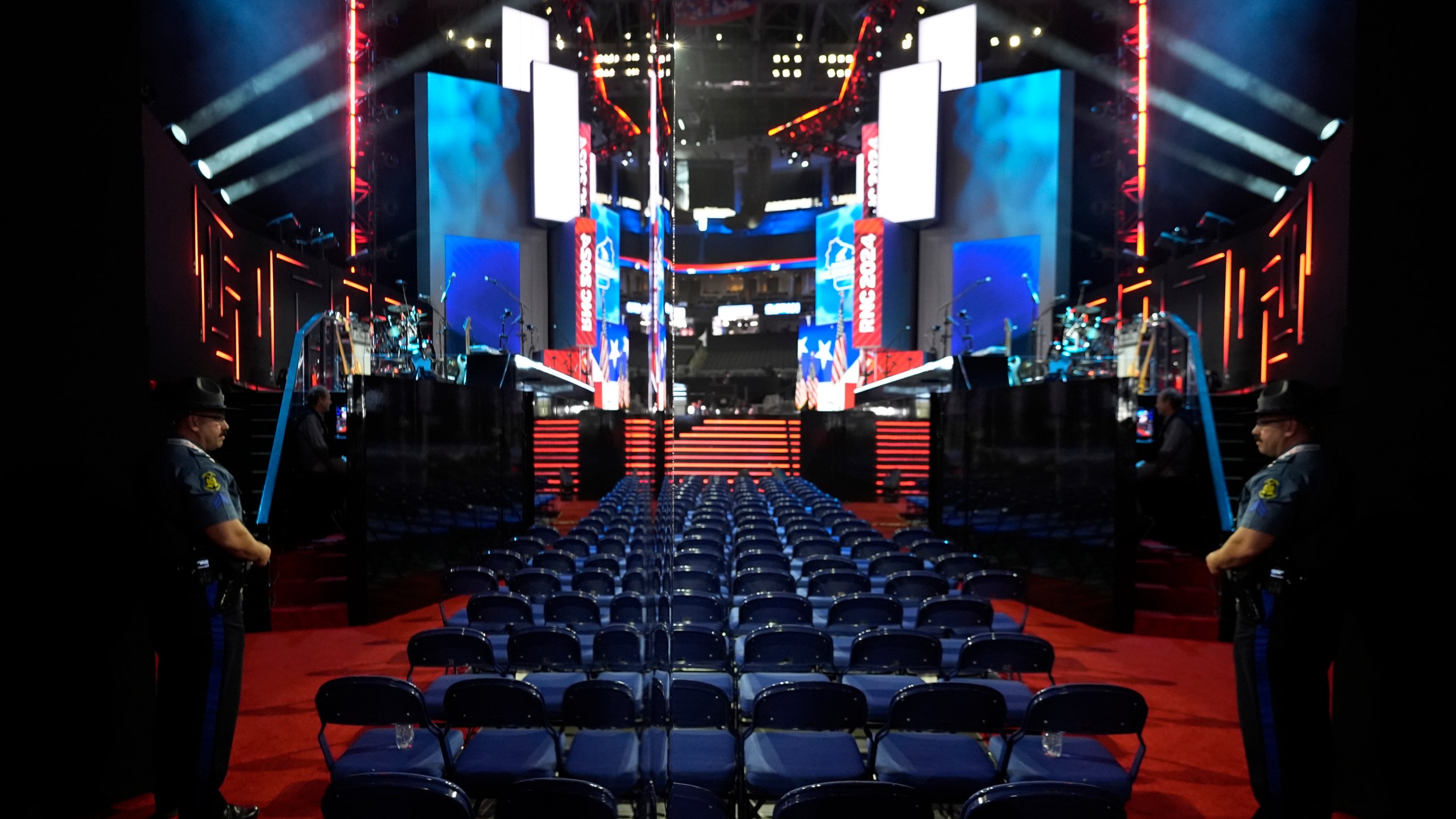 Missouri State Trooper Cpl. Piccinino, right, is reflected in a mylar wall as he stands his post at the 2024 Republican National Convention at the Fiserv Forum, Sunday, July 14, 2024, in Milwaukee. (AP Photo/Charles Rex Arbogast)