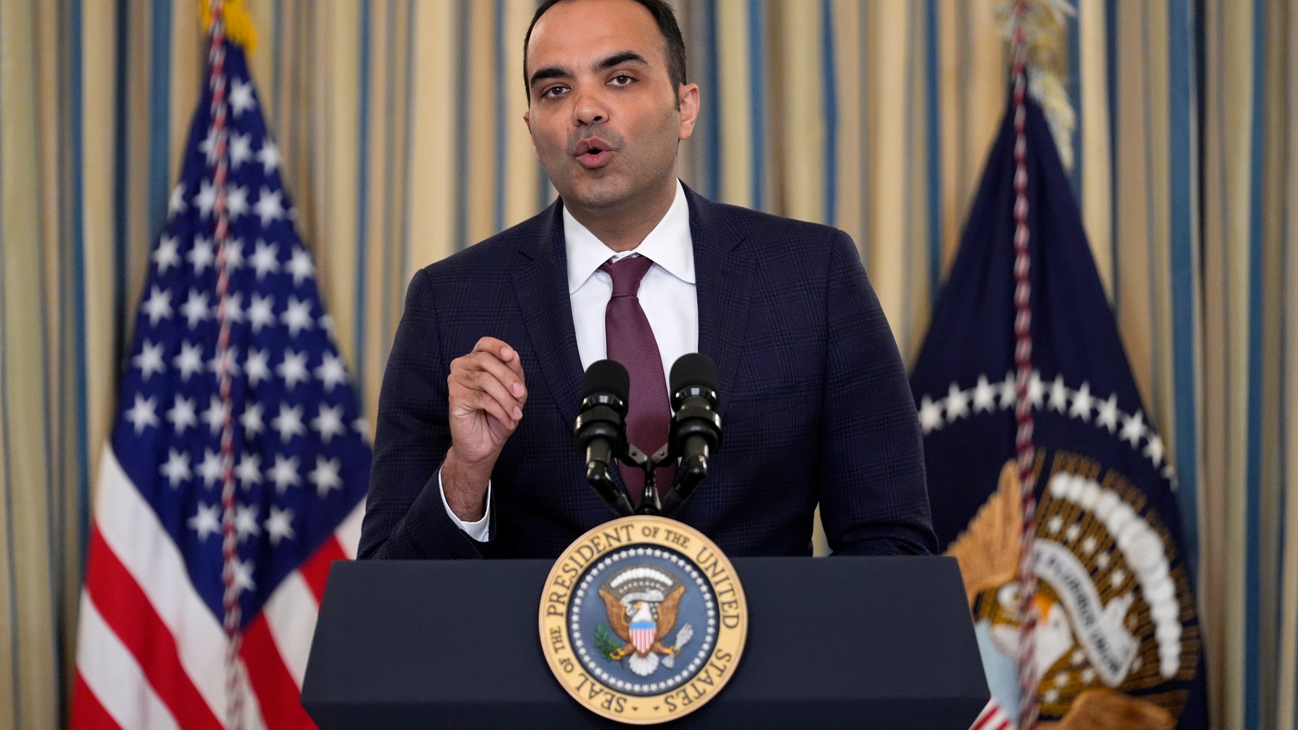 FILE - Rohit Chopra, director of the Consumer Financial Protection Bureau, speaks as President Joe Biden meets with his Competition Council to announce new actions to lower costs for families in the State Dining Room of the White House in Washington, on March 5, 2024. The CFPB said Thursday July 18, 2024 that apps that allow workers to access their paychecks in advance, often for a fee, are providing loans and should be subject to the Truth in Lending Act. (AP Photo/Andrew Harnik, File)