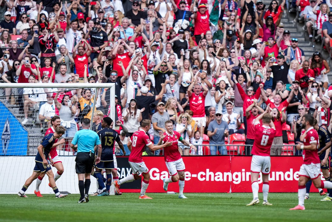 Wrexham's James McClean, back center, and Sam Dalby (18) celebrate McClean's goal against the Vancouver Whitecaps during the second half of an international friendly soccer match in Vancouver, British Columbia, Saturday, July 27, 2024. (Darryl Dyck/The Canadian Press via AP)
