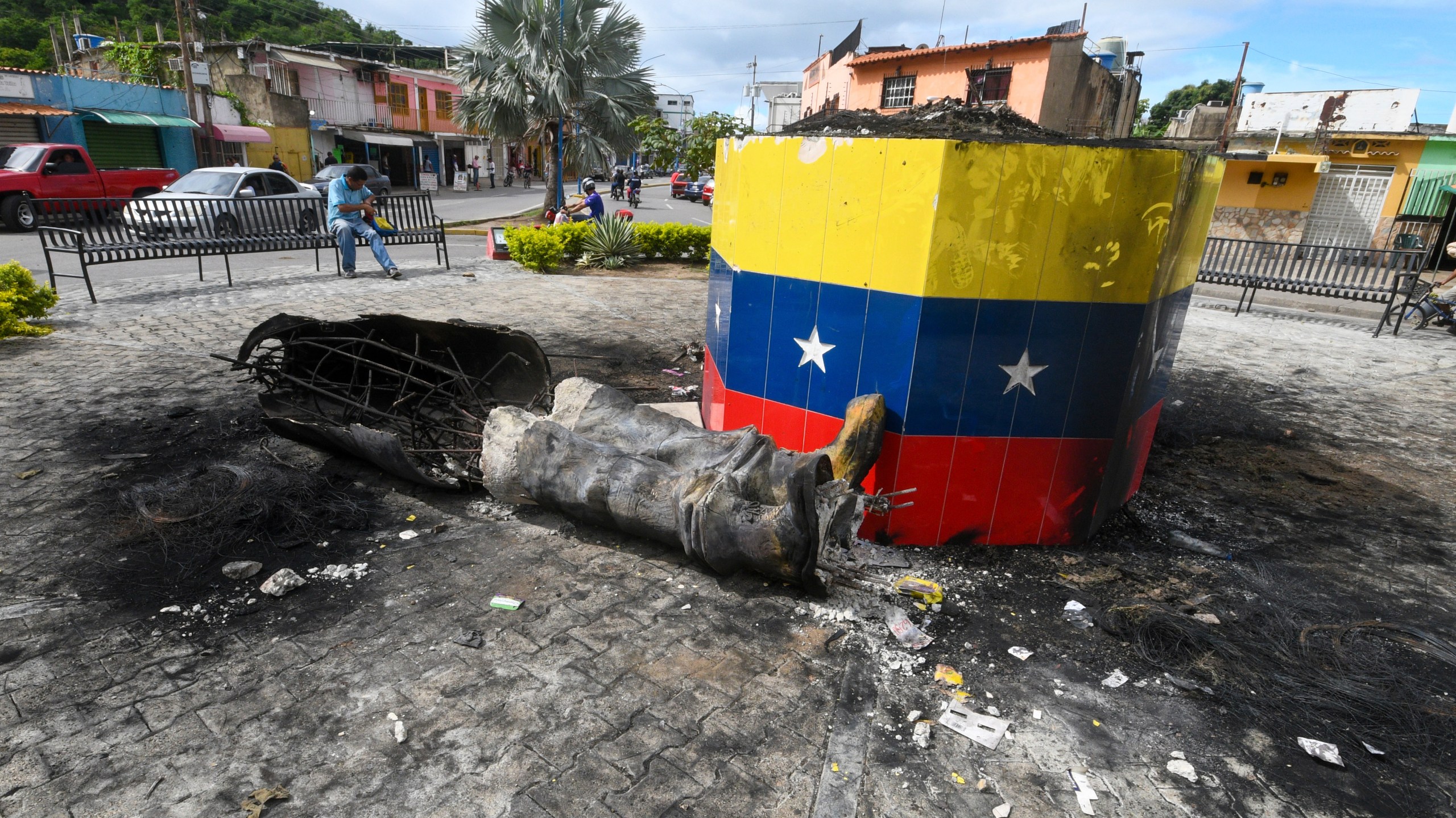 A destroyed statue of the late Venezuelan President Hugo Chavez lays next to its base in Valencia, Venezuela, Tuesday, July 31, 2024, the day after people protested the official election results that certified Chavez's protege, current President Nicolas Maduro, as the winner. (AP Photo/Jacinto Oliveros)