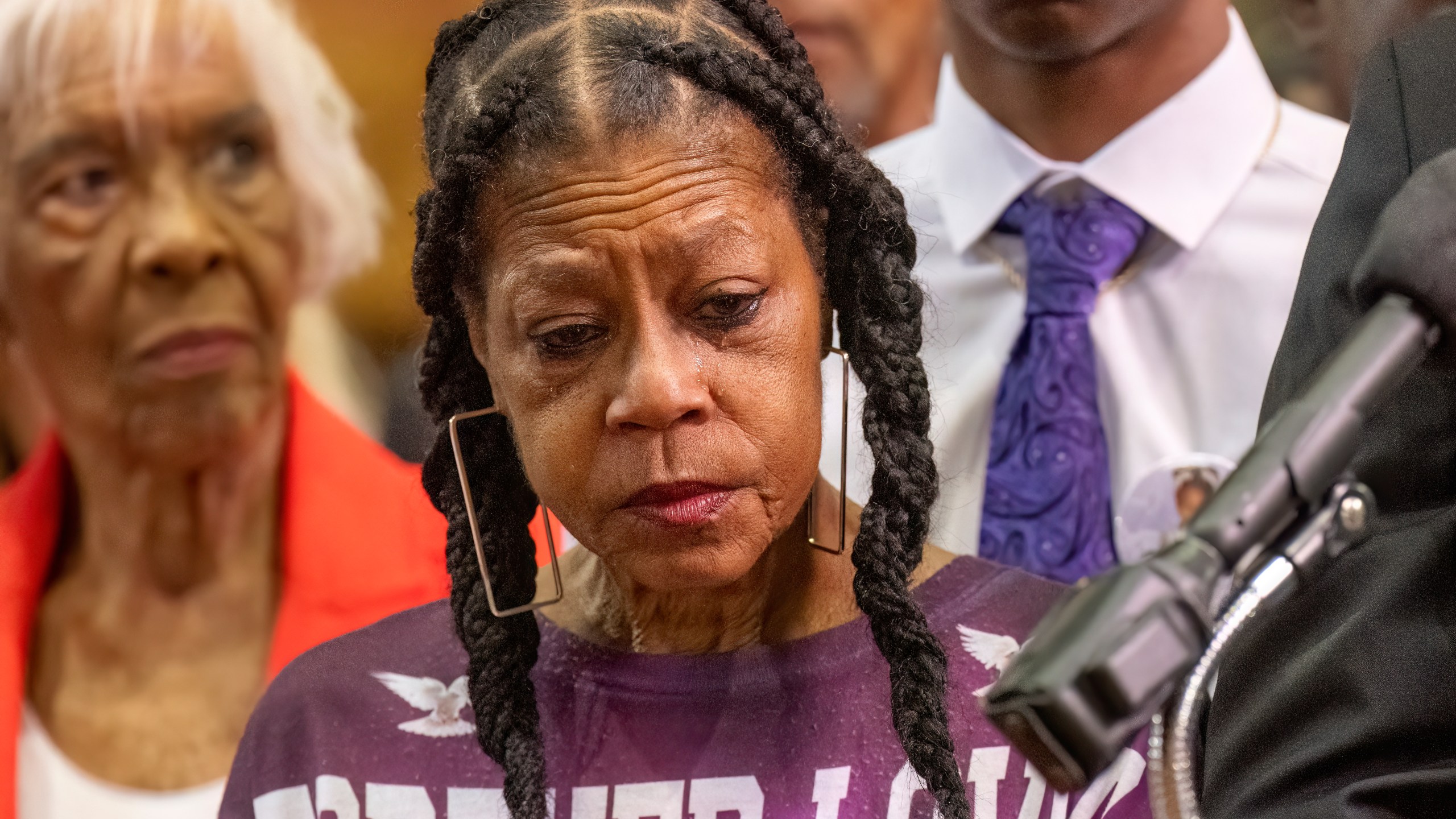 Tears stream down the face of Donna Massey as she listens to Attorney Ben Crump speak during a press conference over the shooting death of her daughter Sonya, who was killed by Illinois sheriff's deputy Sean Grayson, at New Mount Pilgrim Church in the Garfield Park neighborhood in Chicago, Tuesday, July 30, 2024. (Tyler Pasciak LaRiviere/Chicago Sun-Times via AP)