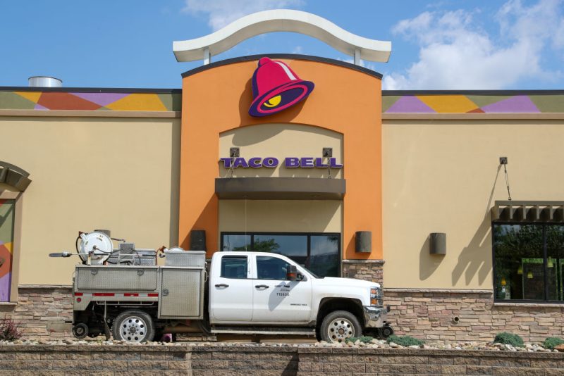 A truck is seen at the drive-thru window of a Taco Bell fast food restaurant.