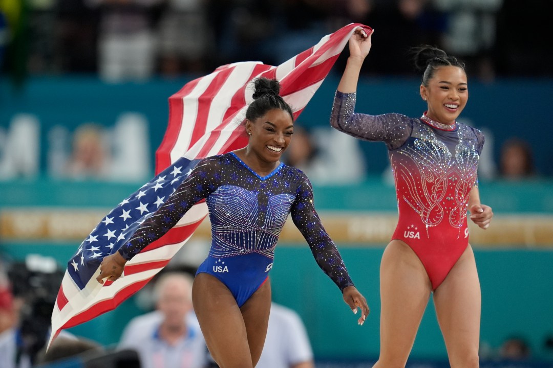 Simone Biles, left, celebrates with teammate Suni Lee, of the United States, after winning the gold and bronze medals respectively in the women's artistic gymnastics all-around finals in Bercy Arena at the 2024 Summer Olympics, Thursday, Aug. 1, 2024, in Paris, France. (AP Photo/Abbie Parr)