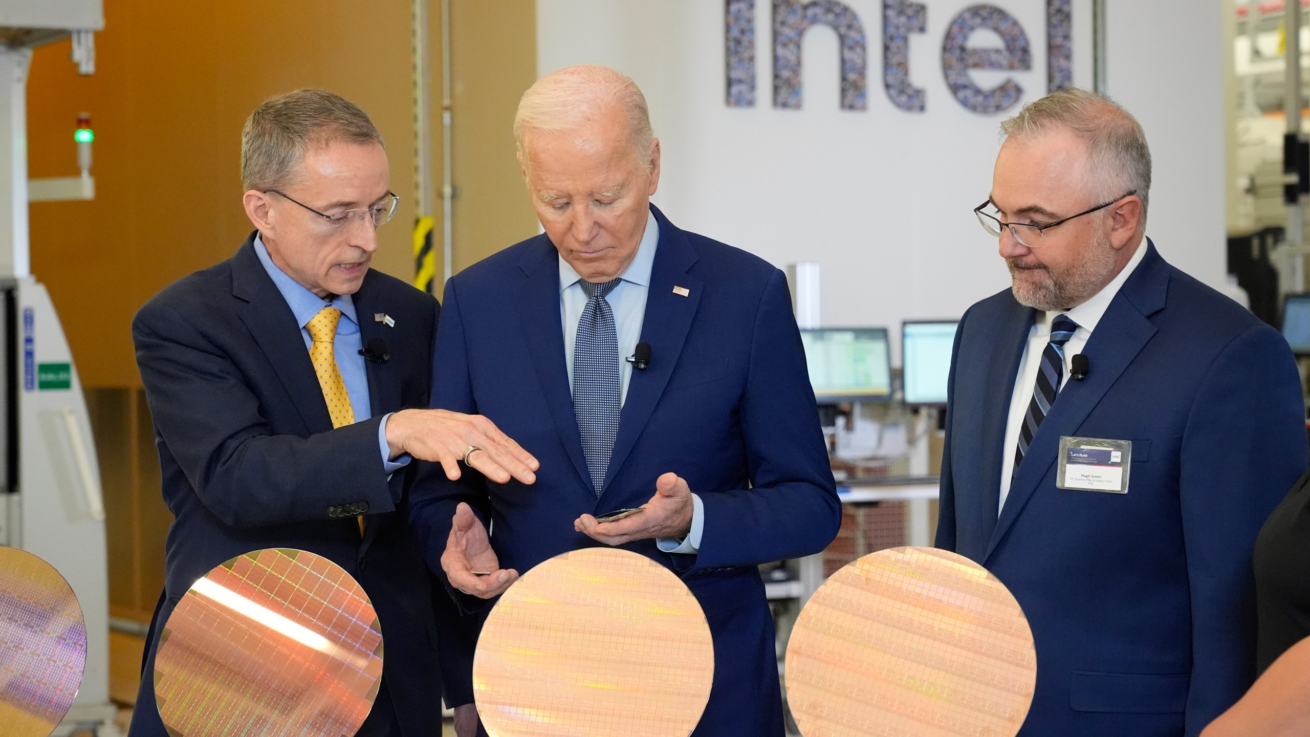 FILE - President Joe Biden listens to Intel CEO Pat Gelsinger, left, as Intel factory manager Hugh Green watches during a tour of the Intel Ocotillo Campus, in Chandler, Ariz., on March 20, 2024. Intel reports earnings on Thursday, Aug. 1, 2024. (AP Photo/Jacquelyn Martin, File)