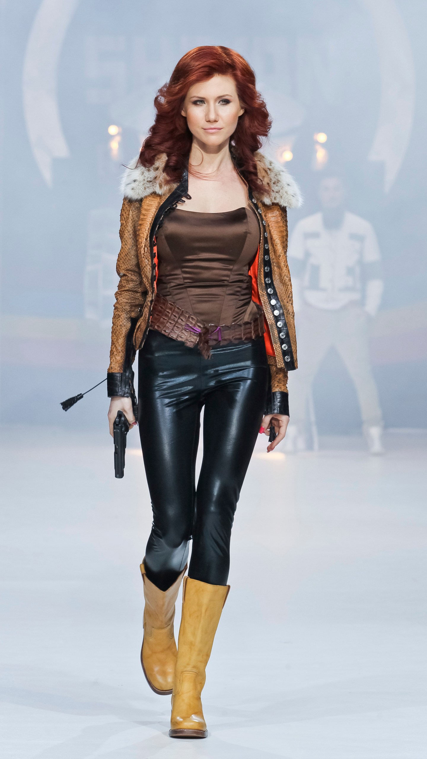 FILE - Anna Chapman, who was deported from the U.S. on charges of espionage, displays a creation by Russian designers Shiyan & Rudkovskaya during a Fashion Week in Moscow, Russia on Sunday, April 3, 2011. In June 2010, U.S. officials rounded up 10 Russians, including Chapman, alleged to be "sleeper agents" — living under false identities without specific espionage missions — to be activated as needed. They were exchanged for four people imprisoned in Russia. (AP Photo /Luba Sheme, File)